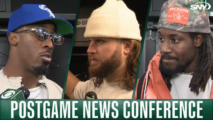 Three New York Jets players speaking at a postgame news conference.