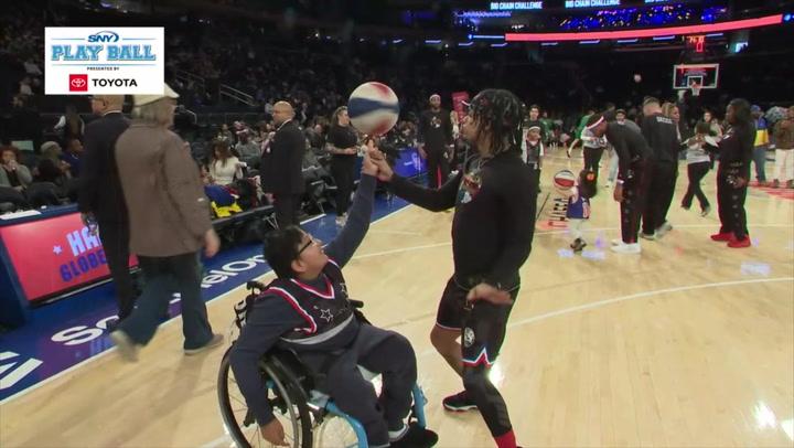 William Zhumi Hidalgo enjoys a Harlem Globetrotter spinning a basketball at Madison Square Garden.