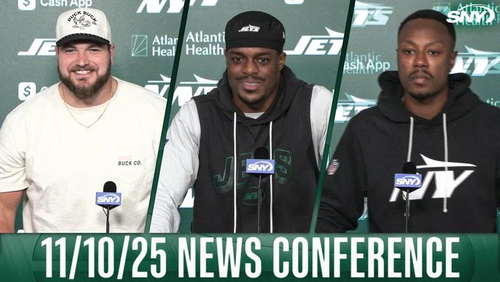 Jets players at 11/10/25 news conference with SNY microphones in front of them.