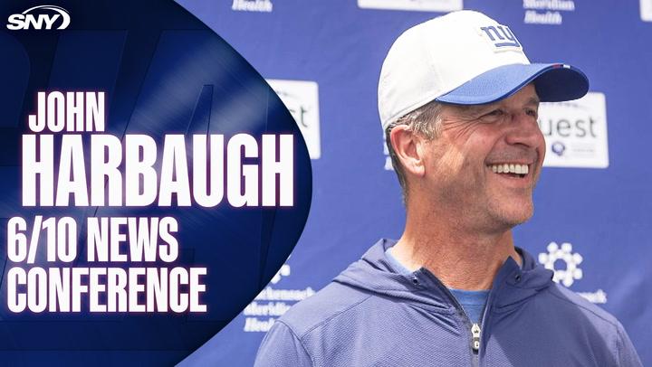 John Harbaugh 6/10 news conference highlighted, with Harbaugh smiling and wearing a Giants hat in front of