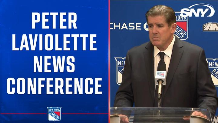 Peter Laviolette discusses the Rangers' 3-2 win over Sharks at a press conference podium.