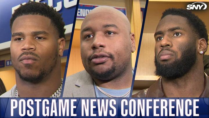 New York Giants players at postgame news conference, SNY logo in corner.