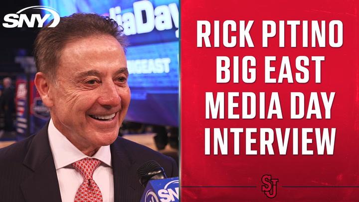 Rick Pitino being interviewed at Big East Media Day, with SNY and St. John's logos visible.