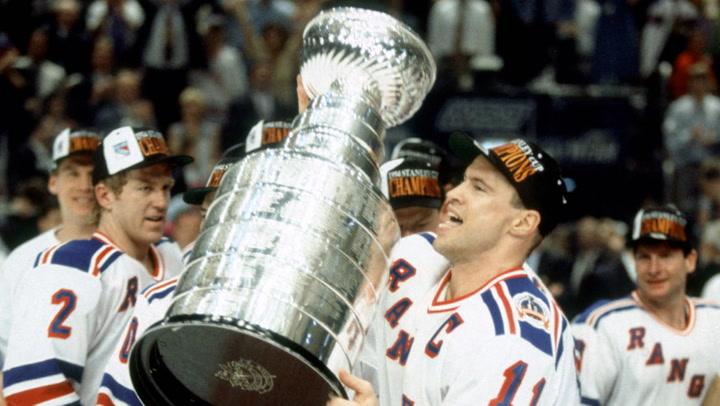 Mark Messier holding trophy.