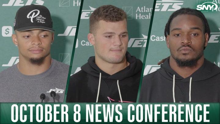 Jets players at October 8 news conference with SNY logo in top right corner.