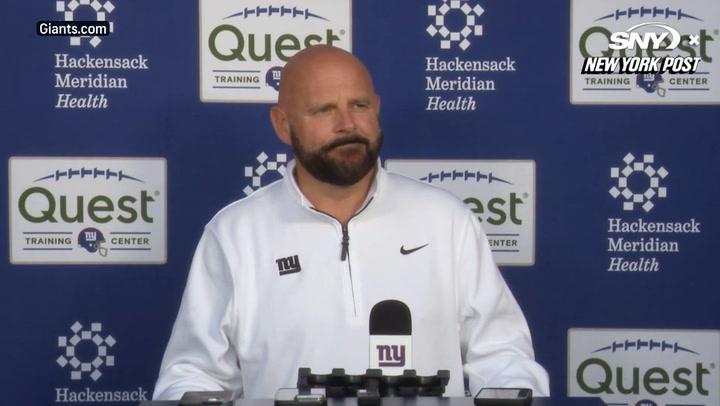 Brian Daboll discusses Giants' Week 6 strategy vs. Commanders at a press conference podium.