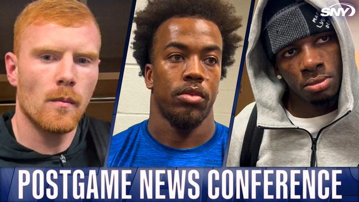 Three New York Giants players at postgame news conference with SNY logo.