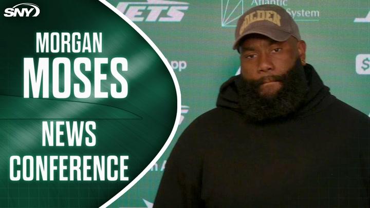 Morgan Moses at a news conference, discussing playing with knee injuries and team resilience.