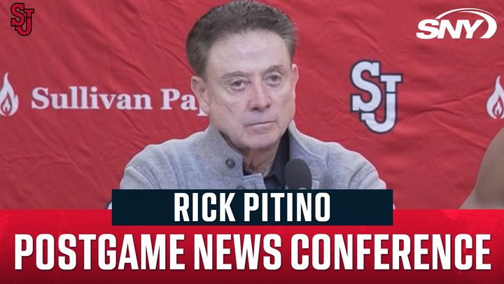 Rick Pitino at St. John's postgame news conference with SNY branding in the background.