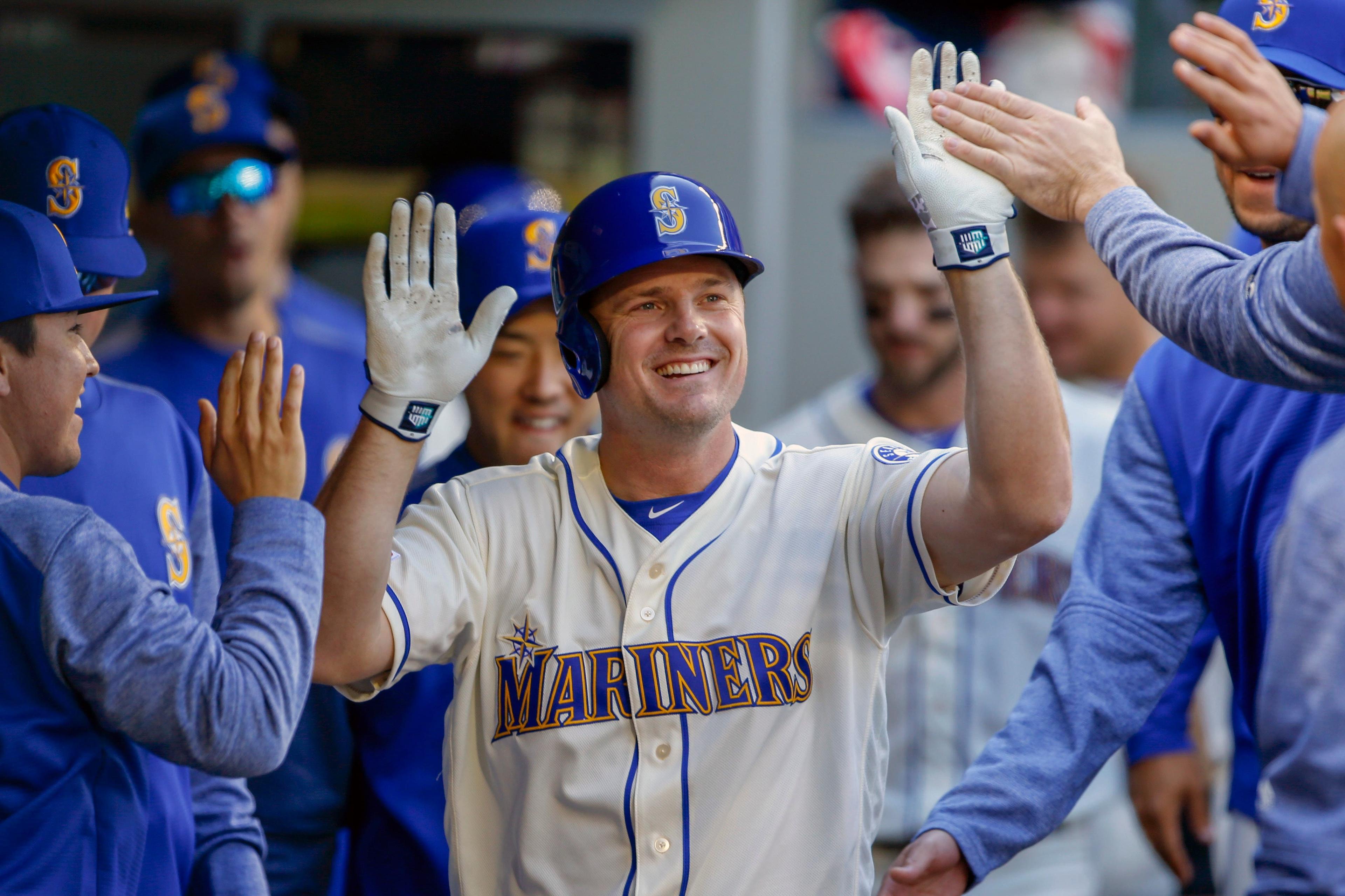 Mar 31, 2019; Seattle, WA, USA; Seattle Mariners first baseman Jay Bruce (32) is congratulated by teammates in the dugout after hitting a solo home run against the Boston Red Sox during the fourth inning at T-Mobile Park. Mandatory Credit: Jennifer Buchanan-USA TODAY Sports / Jennifer Buchanan