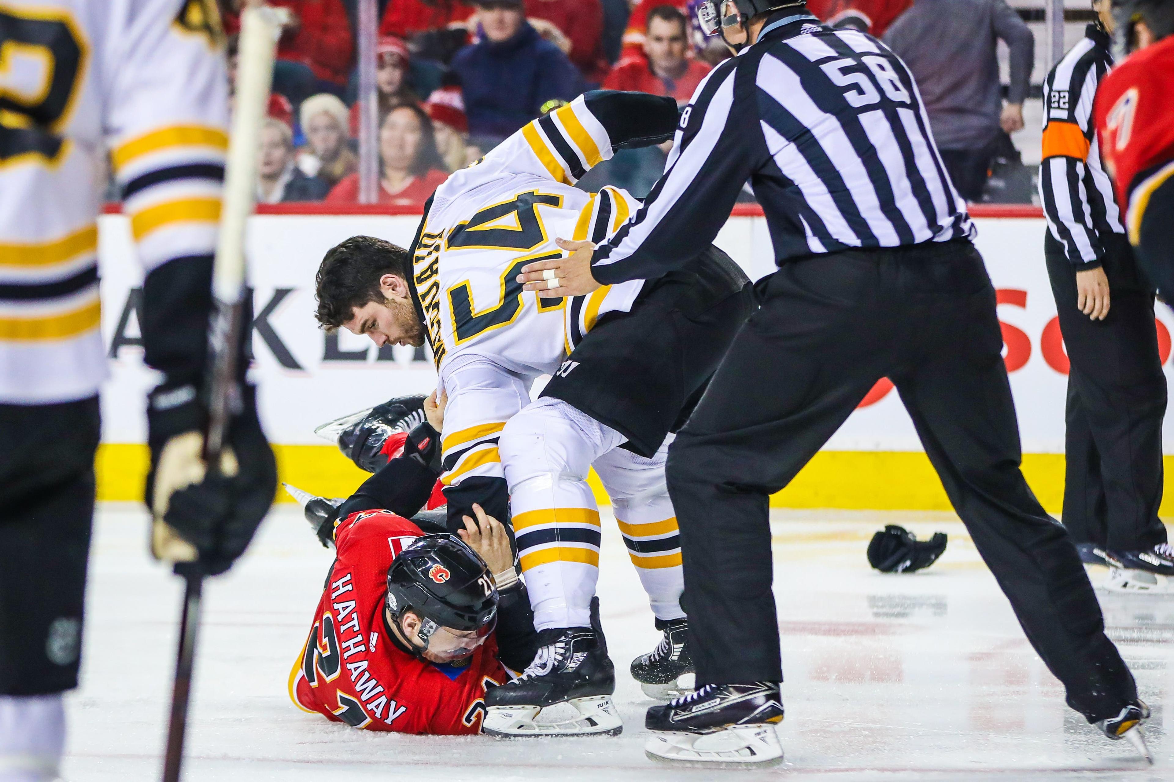 Feb 19, 2018; Calgary, Alberta, CAN; Calgary Flames right wing Garnet Hathaway (21) and Boston Bruins defenseman Adam McQuaid (54) fight during the second period at Scotiabank Saddledome. Mandatory Credit: Sergei Belski-USA TODAY Sports / Sergei Belski