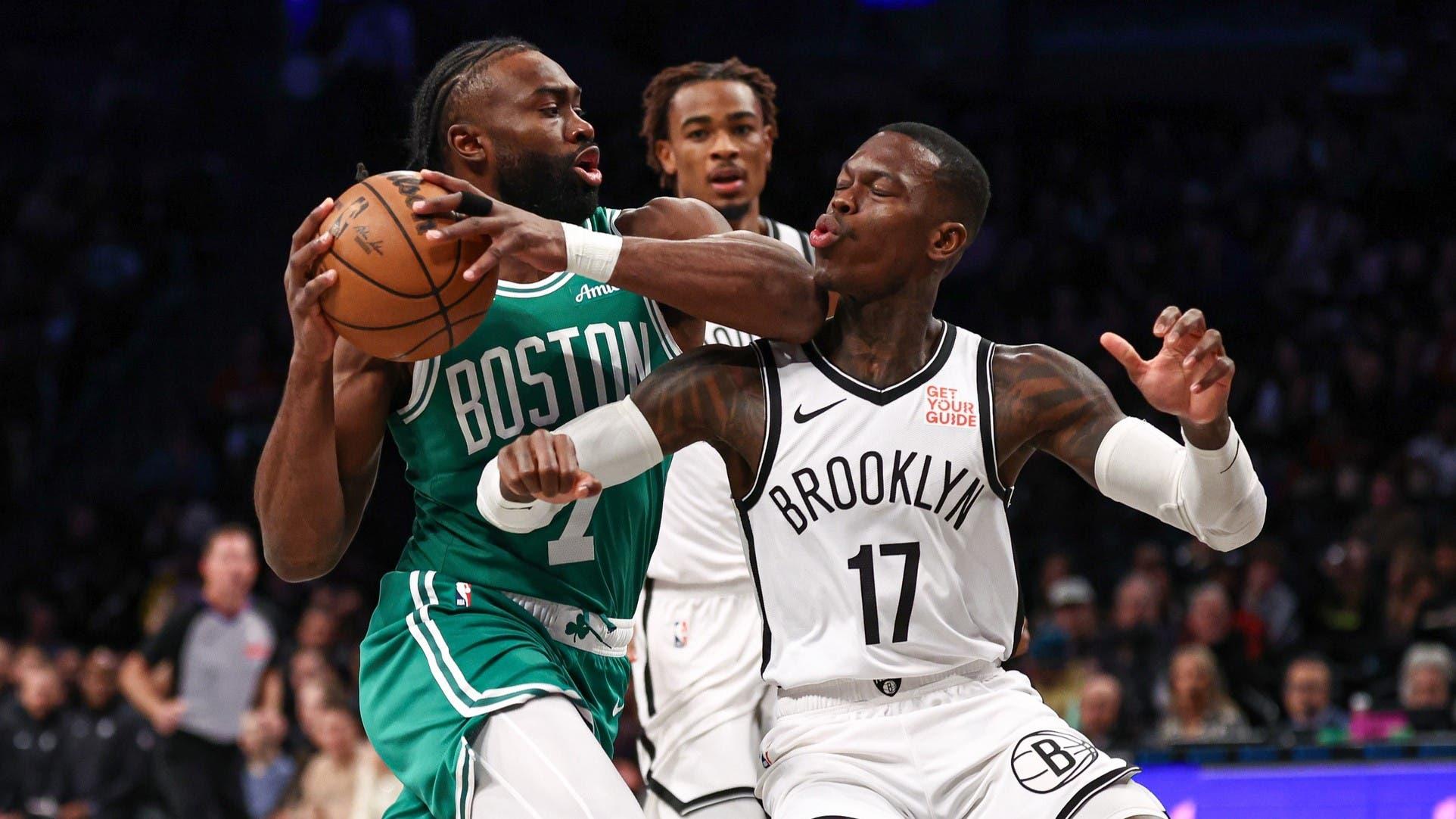 Nov 13, 2024; Brooklyn, New York, USA; Boston Celtics guard Jaylen Brown (7) drives to the basket as Brooklyn Nets guard Dennis Schroder (17) defends during the first quarter at Barclays Center. / Vincent Carchietta-Imagn Images