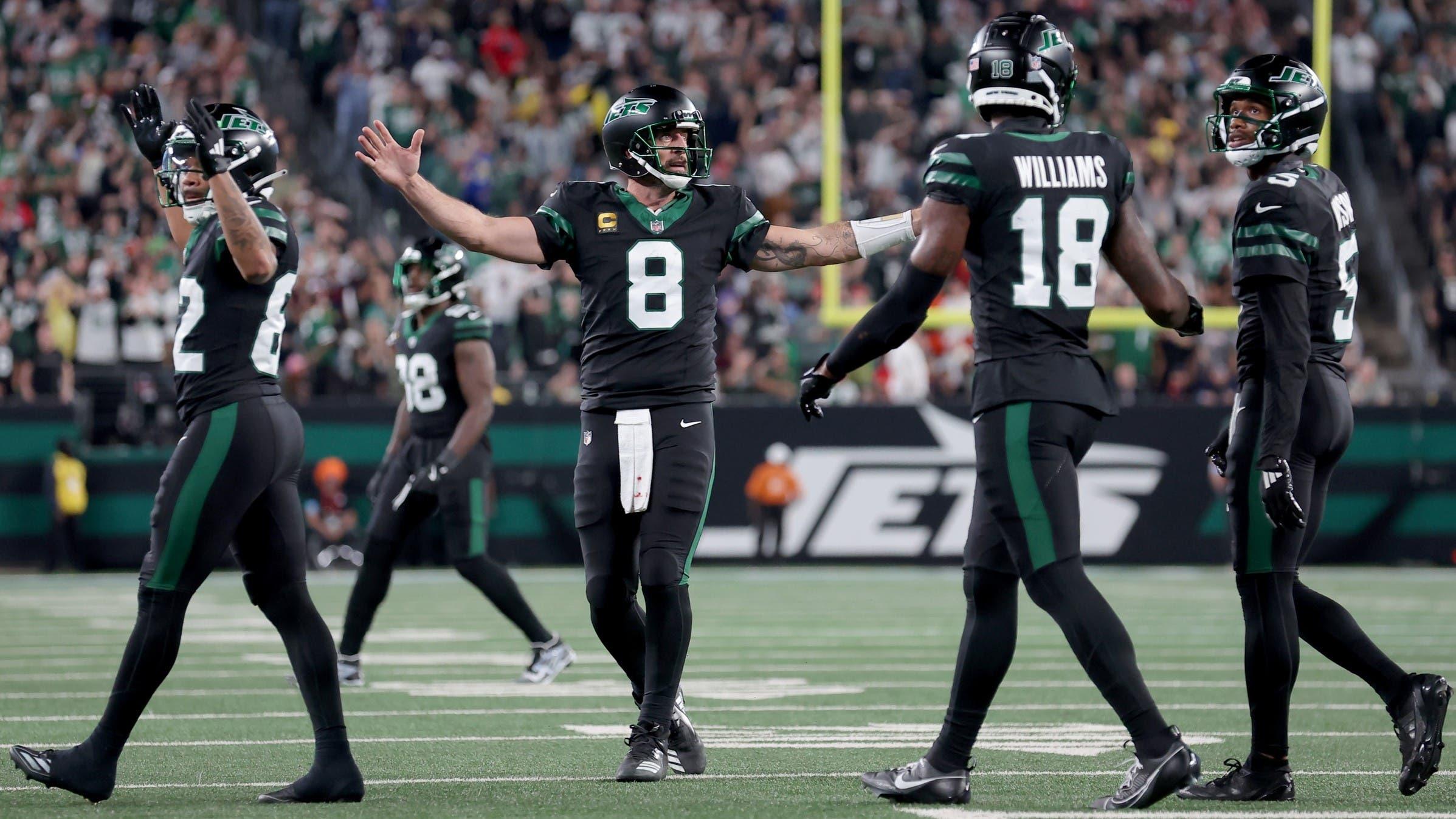 Oct 31, 2024; East Rutherford, New Jersey, USA; New York Jets quarterback Aaron Rodgers (8) reacts after a touchdown against the Houston Texans by wide receiver Garrett Wilson (5) during the fourth quarter at MetLife Stadium.