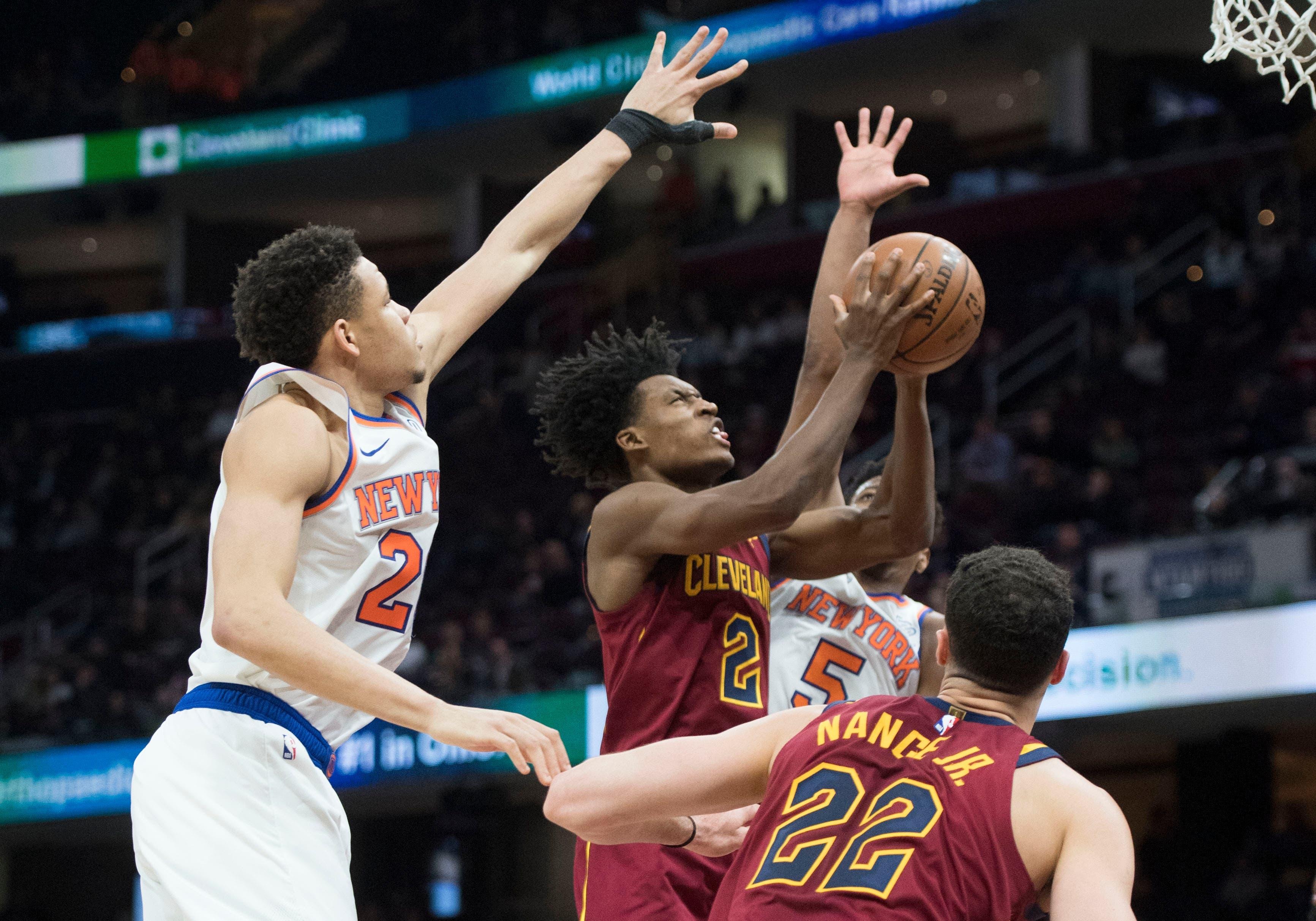 Feb 11, 2019; Cleveland, OH, USA; Cleveland Cavaliers guard Collin Sexton (2) drives to the basket between New York Knicks forward Kevin Knox (20) and guard Dennis Smith Jr. (5) during the second half at Quicken Loans Arena. Mandatory Credit: Ken Blaze-USA TODAY Sports / Ken Blaze