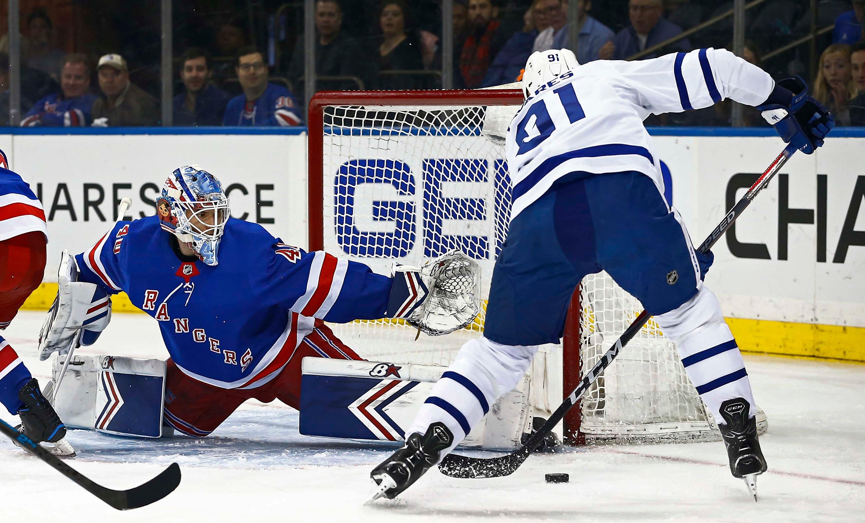 New York Rangers goaltender Alexandar Georgiev defends against Toronto Maple Leafs center John Tavares during the first period at Madison Square Garden. / Noah K. Murray/USA TODAY Sports