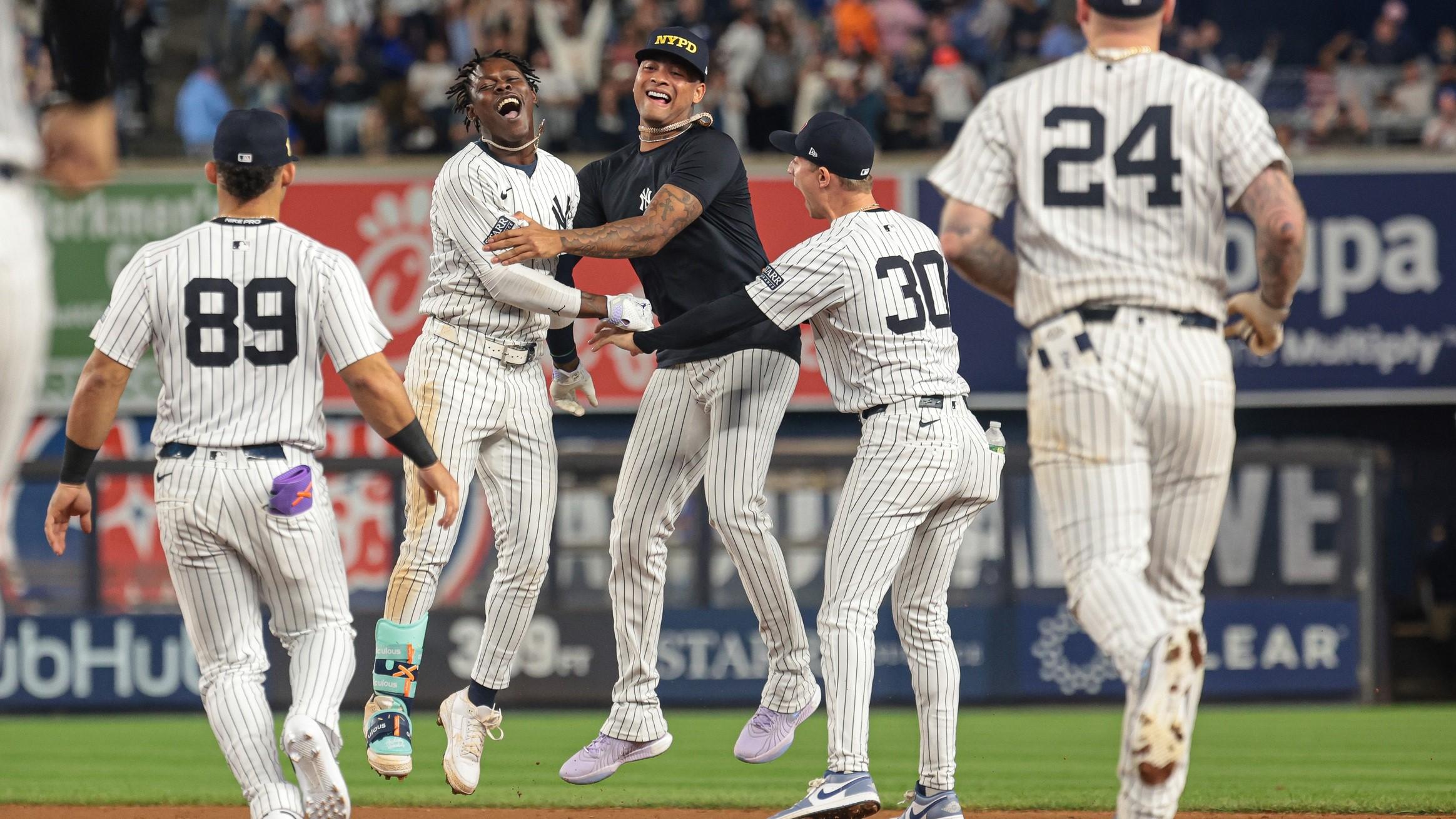 Sep 11, 2024; Bronx, New York, USA; New York Yankees third baseman Jazz Chisholm Jr. (13) celebrates with starting pitcher Luis Gil (81) and teammates after hitting a game winning RBI single during the eleventh inning against the Kansas City Royals at Yankee Stadium.