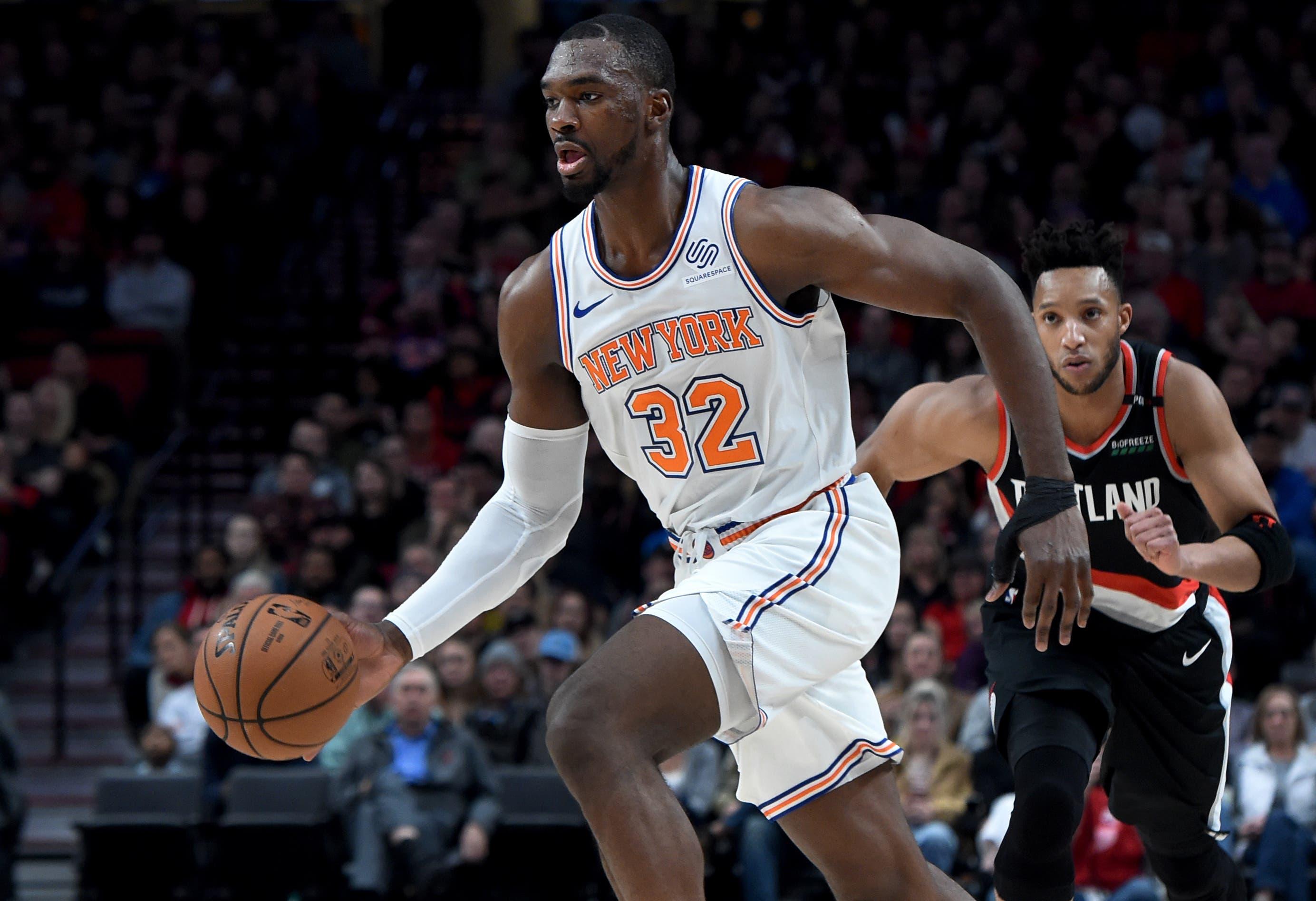 New York Knicks forward Noah Vonleh drives to the basket past Portland Trail Blazers guard Evan Turner during the first quarter at the Moda Center. / Steve Dykes/USA TODAY Sports