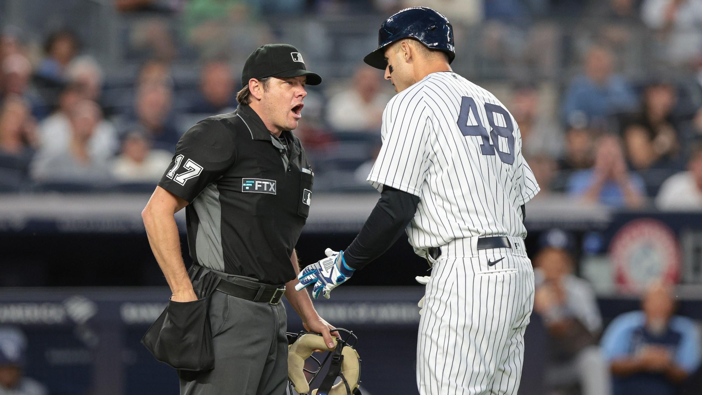 Aug 15, 2022; Bronx, New York, USA; New York Yankees first baseman Anthony Rizzo (48) talks with umpire DJ Reyburn (17) during the third inning against the Tampa Bay Rays at Yankee Stadium