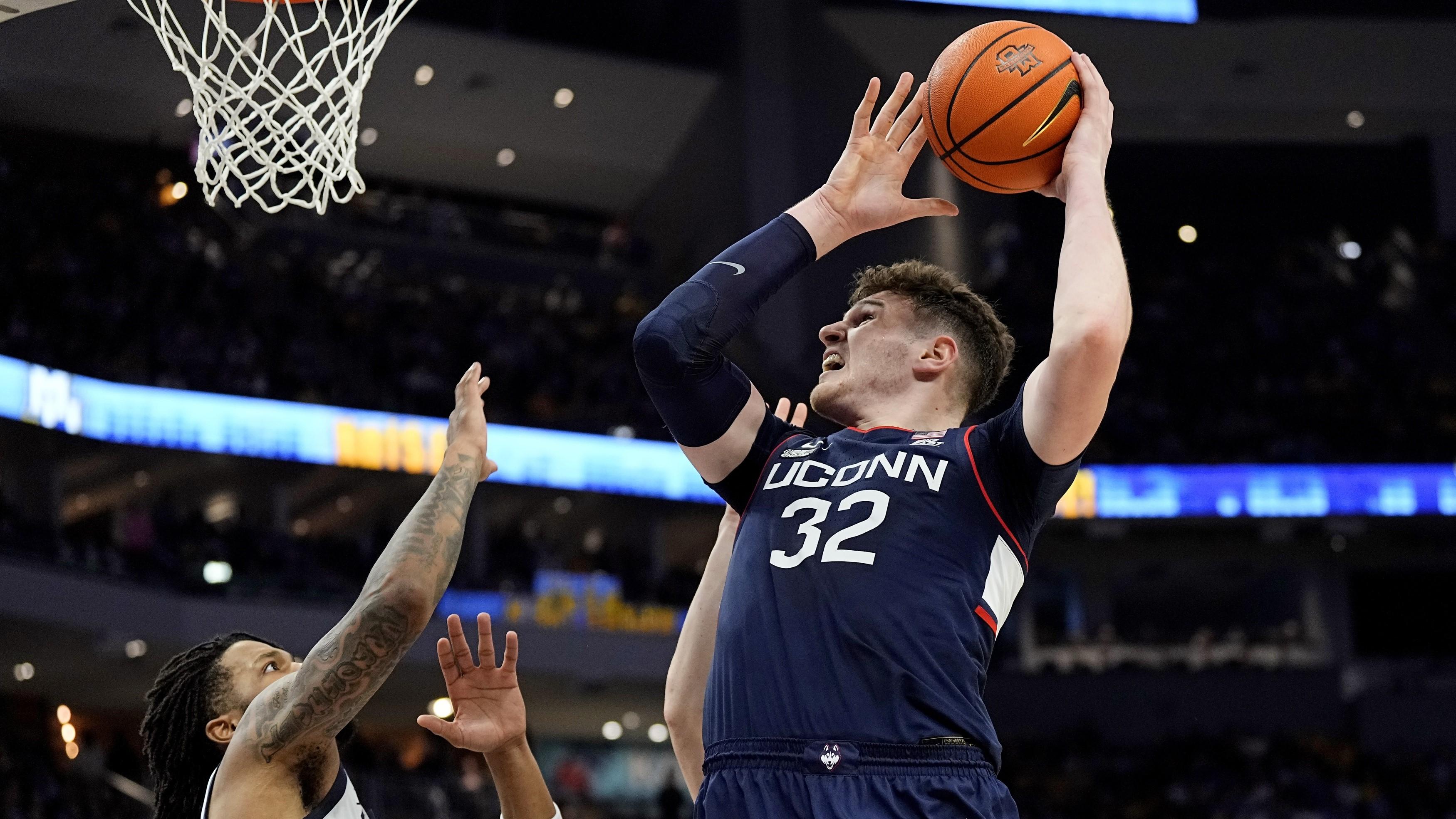 Mar 6, 2024; Milwaukee, Wisconsin, USA; Connecticut Huskies center Donovan Clingan (32) shoots during the first half against the Marquette Golden Eagles at Fiserv Forum. / Jeff Hanisch-USA TODAY Sports