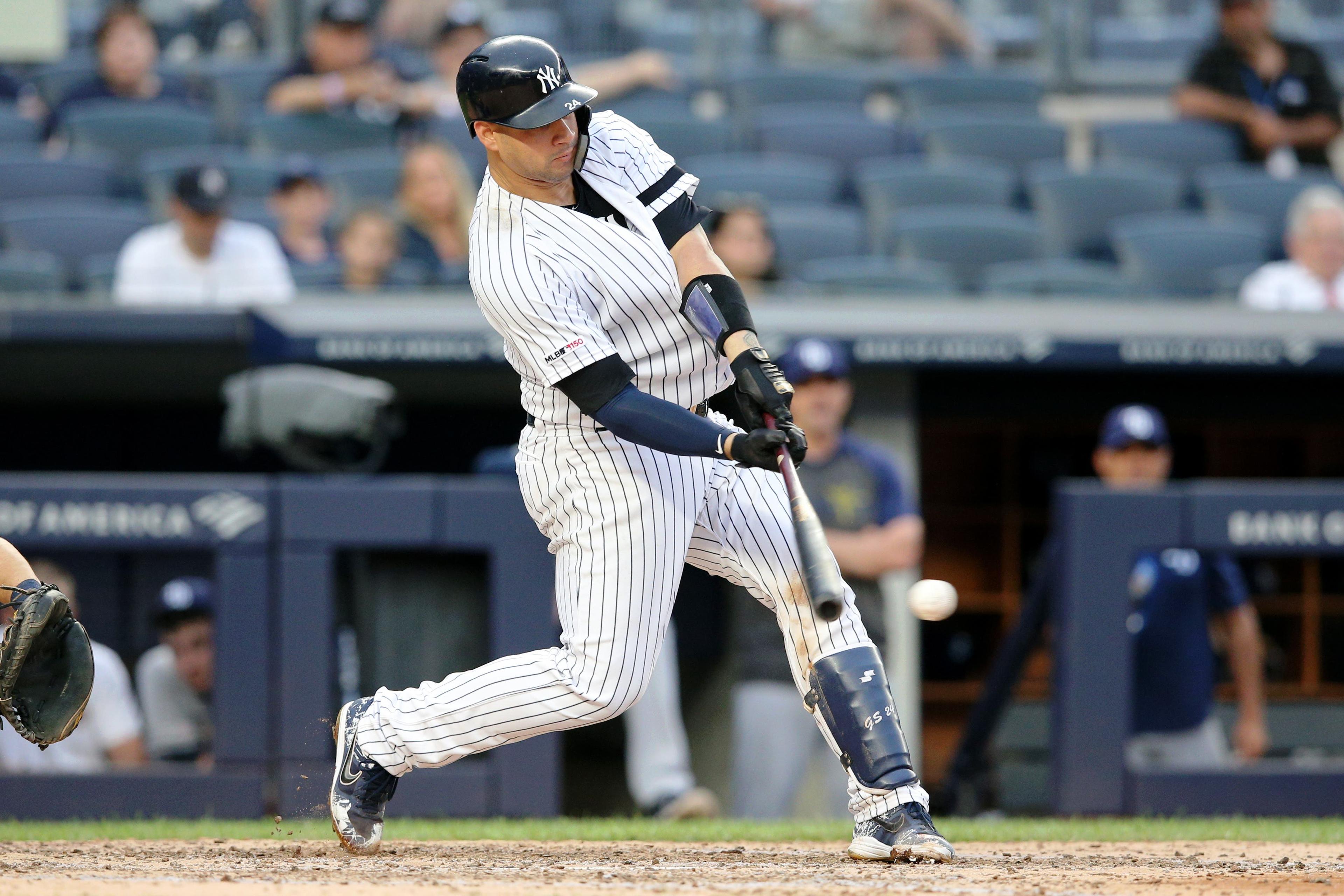 Jul 18, 2019; Bronx, NY, USA; New York Yankees catcher Gary Sanchez (24) hits an RBI single against the Tampa Bay Rays during the fifth inning of the first game of a doubleheader at Yankee Stadium. Mandatory Credit: Brad Penner-USA TODAY Sports / Brad Penner