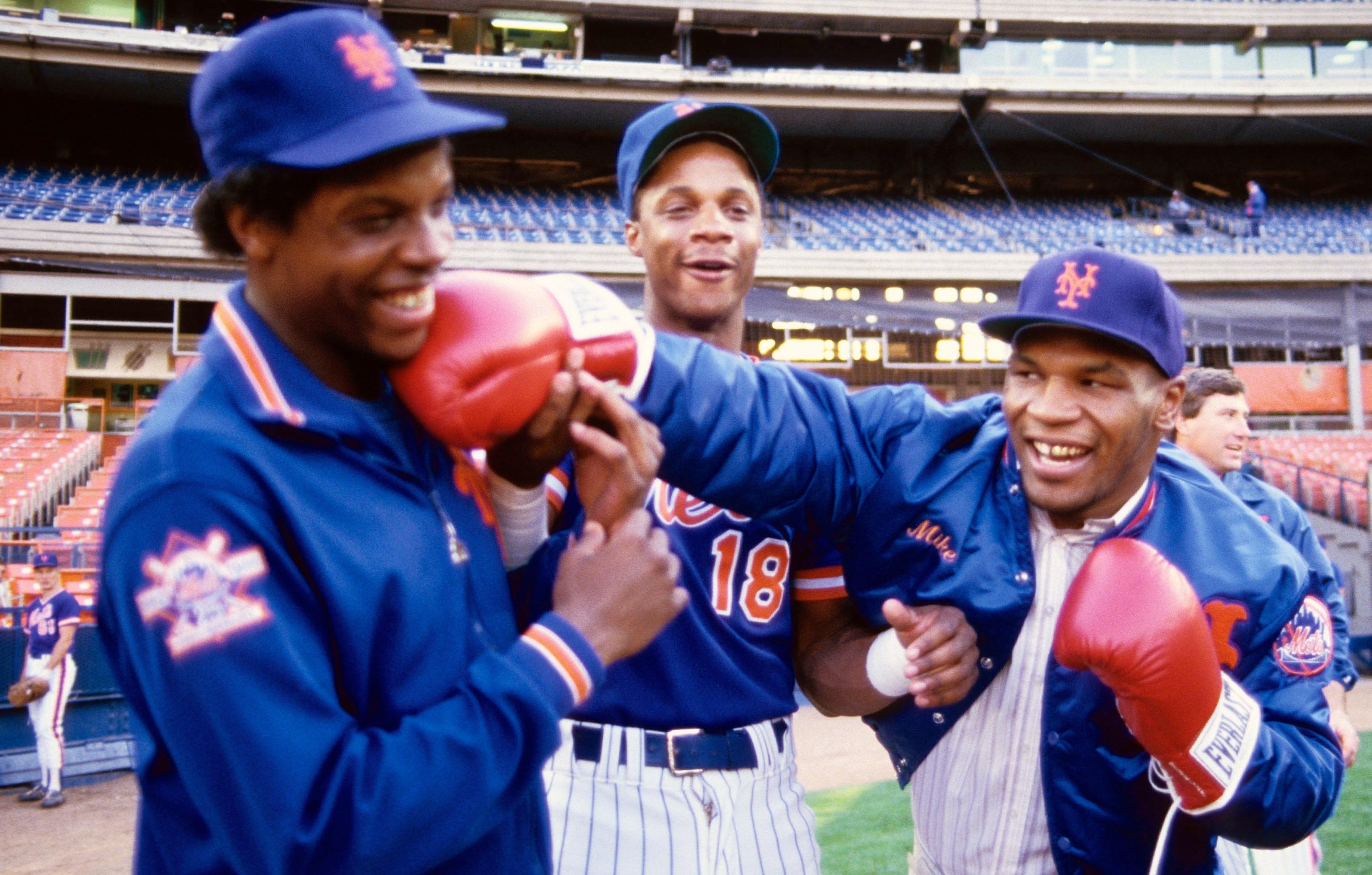 Dwight Gooden and right fielder Darryl Strawberry (18) joke around on the field with boxer Mike Tyson before a game at Shea Stadium. Mandatory Credit: Tony Tomsic-USA TODAY NETWORK