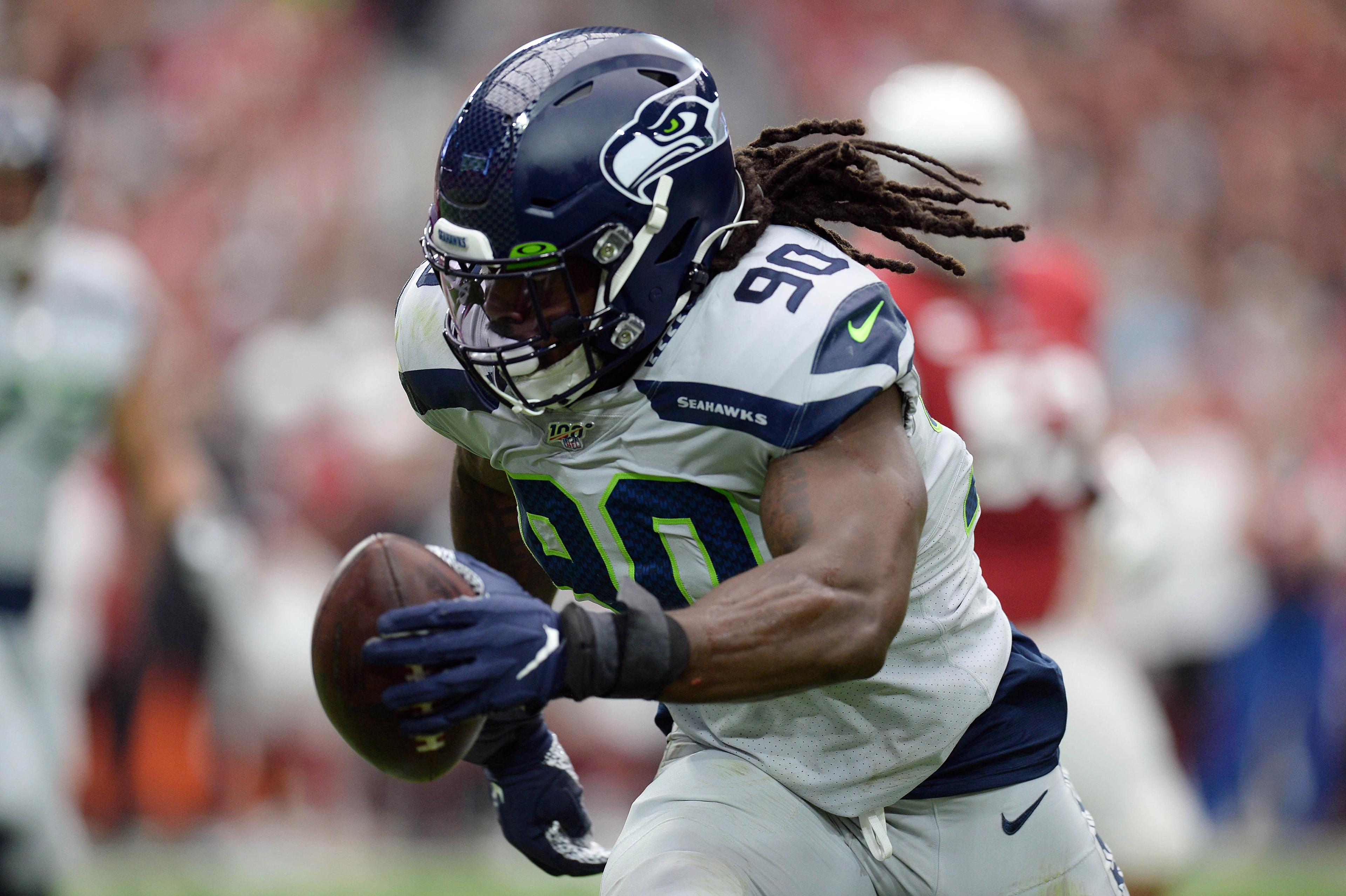 Sep 29, 2019; Glendale, AZ, USA; Seattle Seahawks outside linebacker Jadeveon Clowney (90) returns an interception for a touchdown against the Arizona Cardinals during the first half at State Farm Stadium. Mandatory Credit: Joe Camporeale-USA TODAY Sports / Joe Camporeale