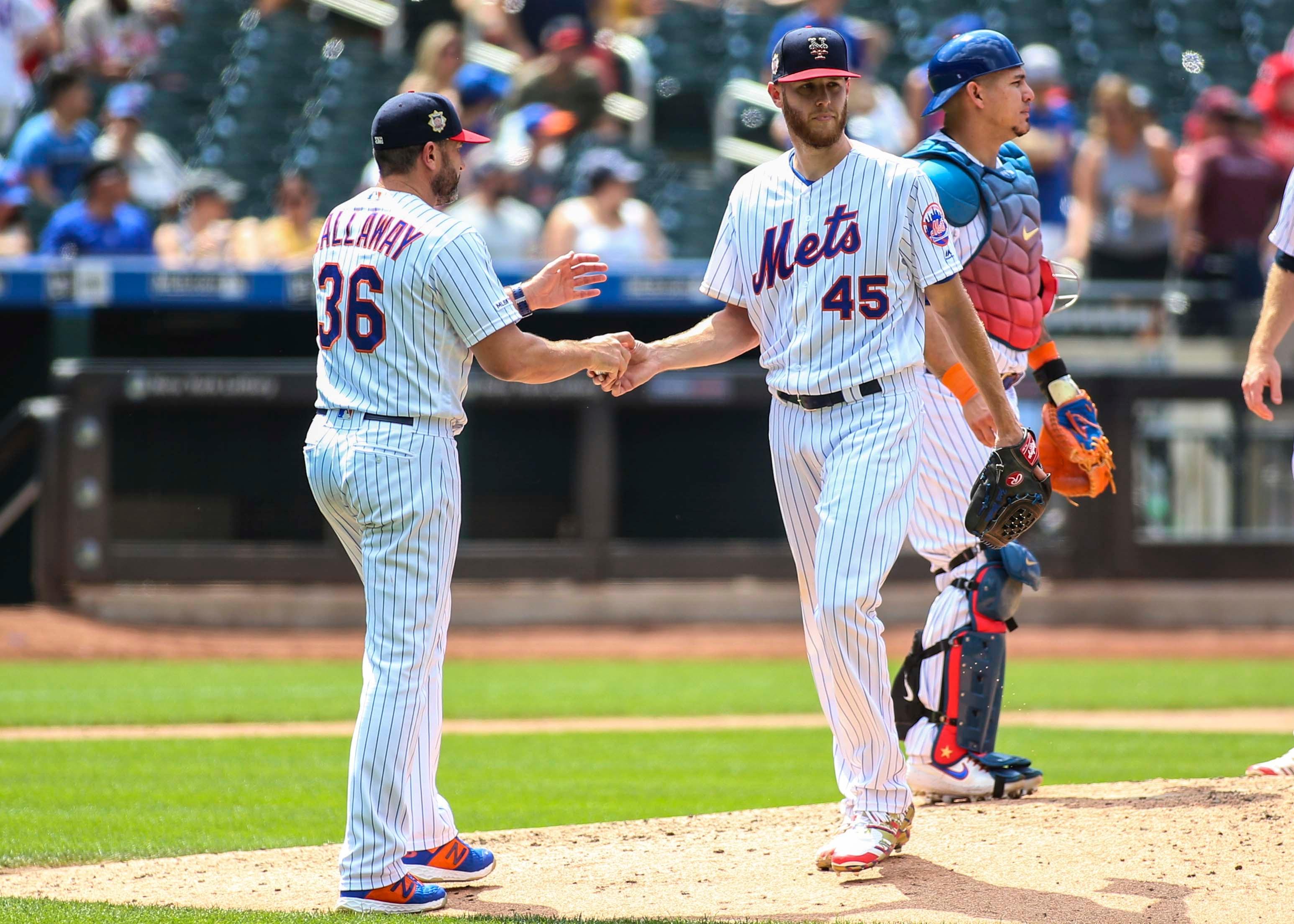 Jul 7, 2019; New York City, NY, USA; New York Mets manager Mickey Callaway (36) takes out pitcher Zack Wheeler (45) in the sixth inning against the Philadelphia Phillies at Citi Field. Mandatory Credit: Wendell Cruz-USA TODAY Sports