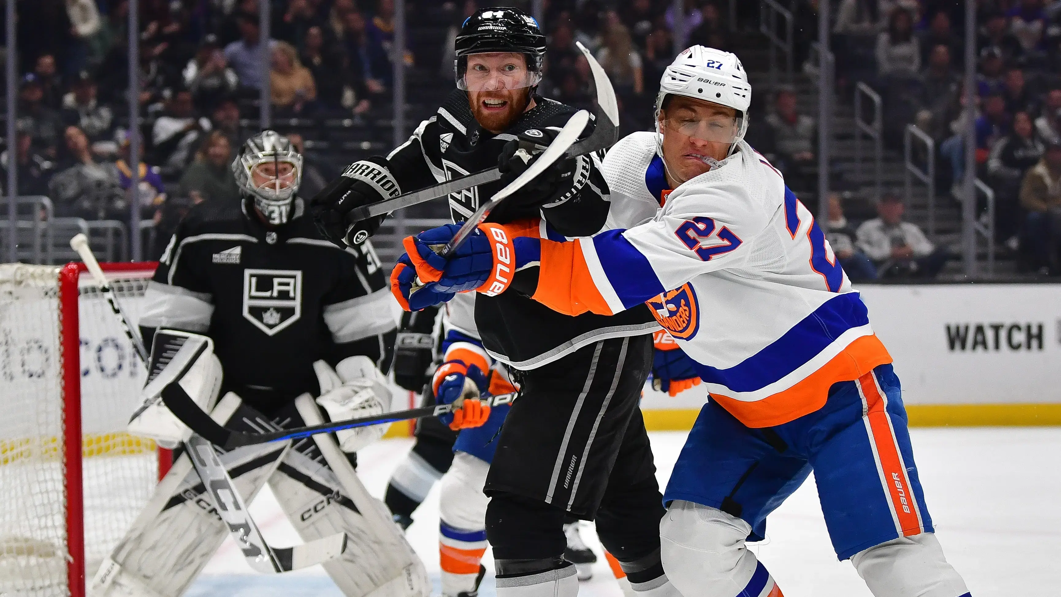 Los Angeles Kings defenseman Vladislav Gavrikov (84) plays for the puck against New York Islanders left wing Anders Lee (27) during the first period at Crypto.com Arena / Gary A. Vasquez - USA TODAY Sports