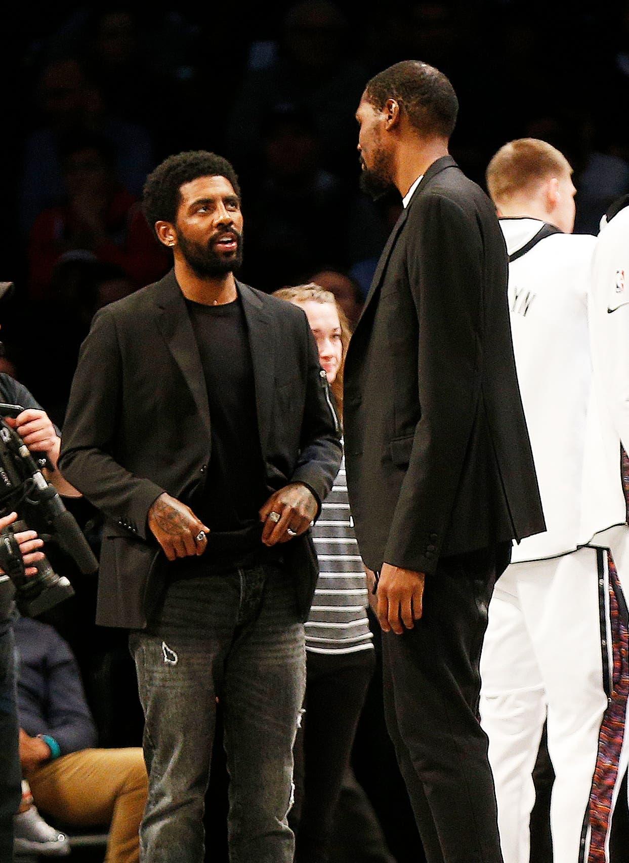 Nov 29, 2019; Brooklyn, NY, USA; Brooklyn Nets injured players Kyrie Irving (left) and Kevin Durant talk during a timeout against Boston Celtics during the second half at Barclays Center. Mandatory Credit: Andy Marlin-USA TODAY Sportsundefined