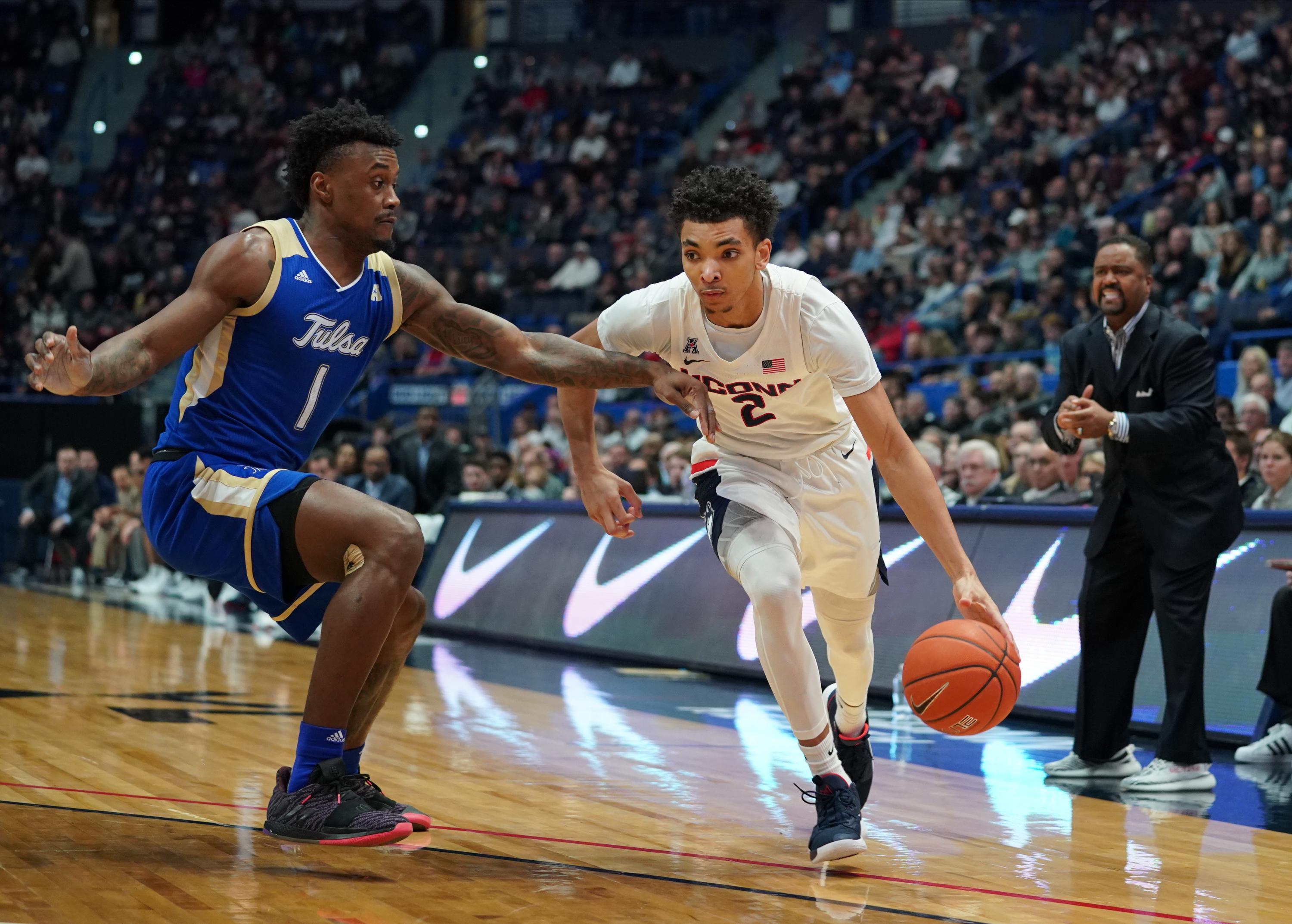 Jan 26, 2020; Hartford, Connecticut, USA; Connecticut Huskies guard James Bouknight (2) drives the ball against Tulsa Golden Hurricane forward Martins Igbanu (1) in the first half at XL Center. Mandatory Credit: David Butler II-USA TODAY Sports