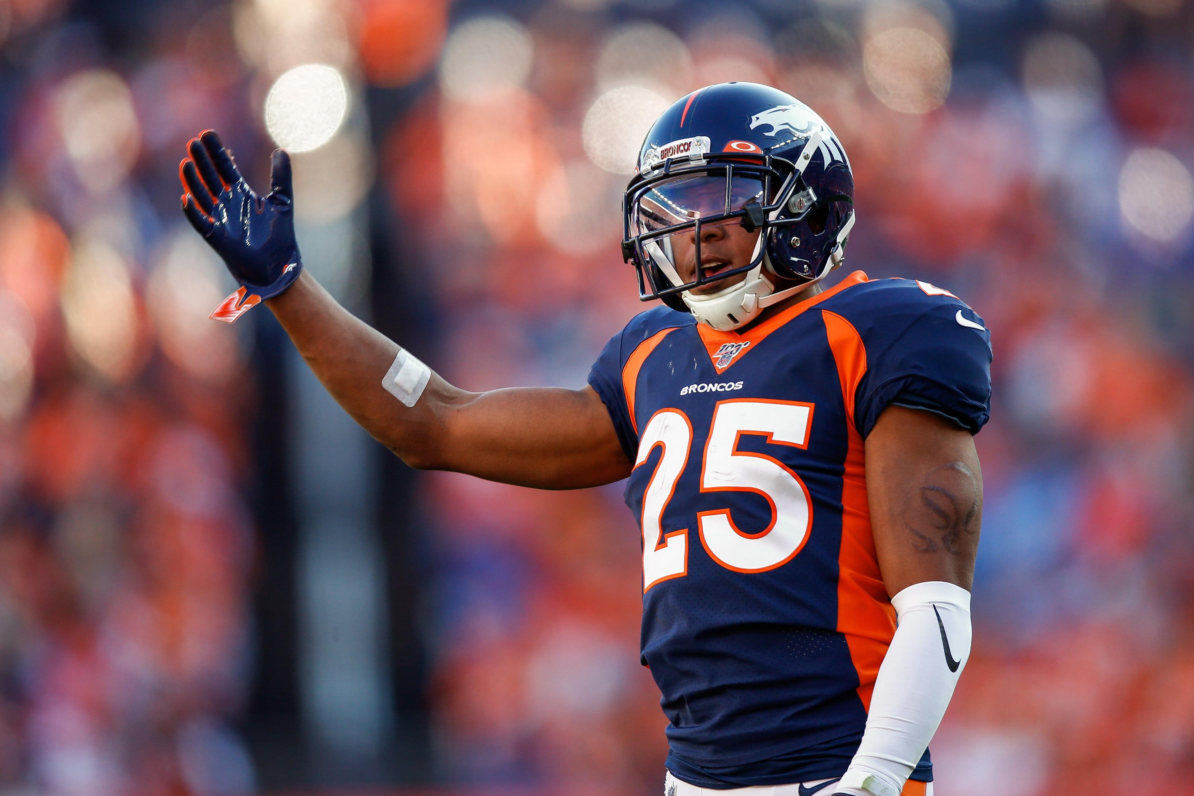 Oct 13, 2019; Denver, CO, USA; Denver Broncos cornerback Chris Harris Jr. (25) motions in the third quarter against the Tennessee Titans at Empower Field at Mile High. / Isaiah J. Downing/USA TODAY Sports