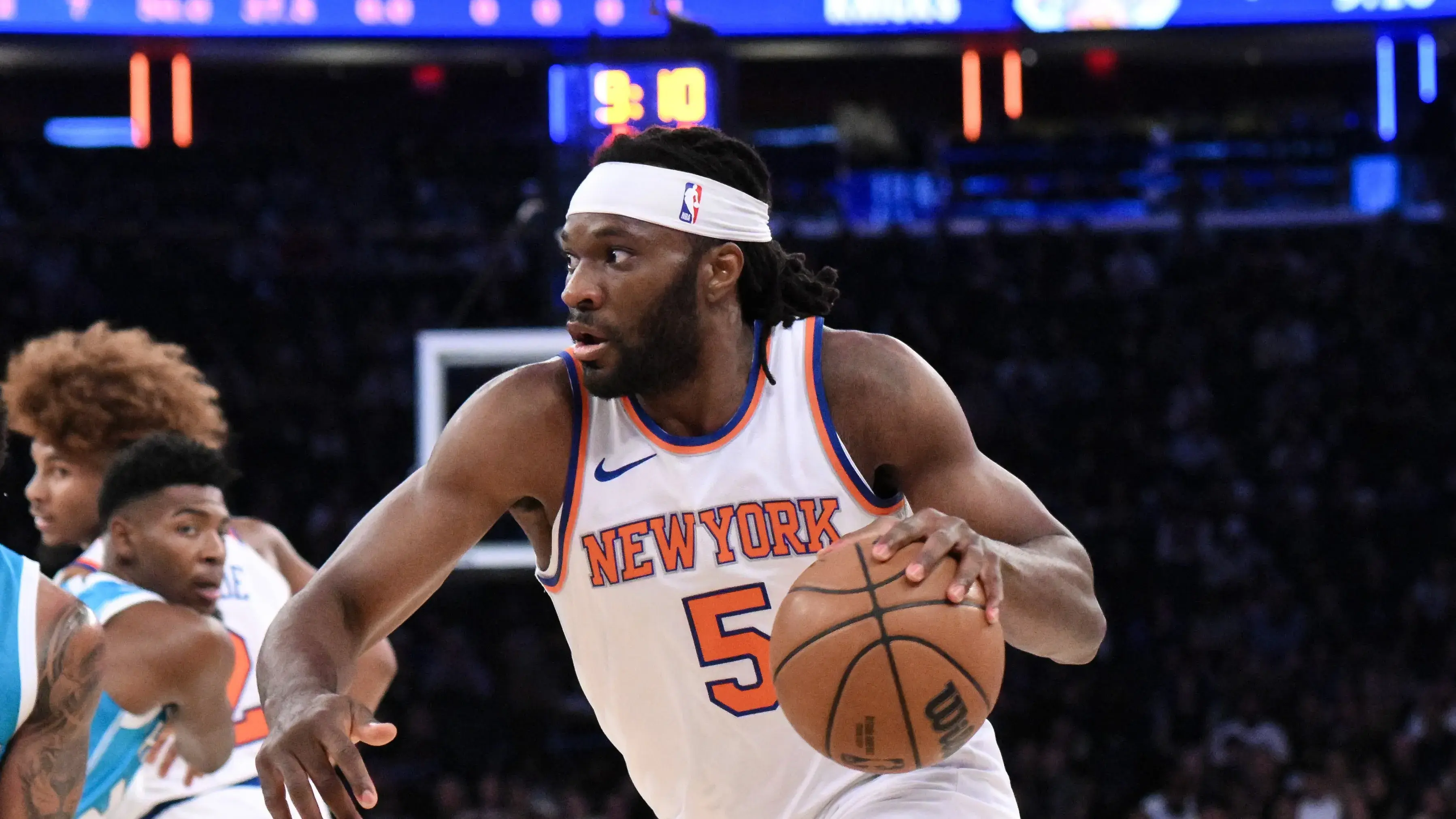 Oct 15, 2024; New York, New York, USA; New York Knicks forward Precious Achiuwa (5) drives to the basket while being defended by Charlotte Hornets forward Miles Bridges (0) during the first half at Madison Square Garden. Mandatory Credit: John Jones-Imagn Images / © John Jones-Imagn Images