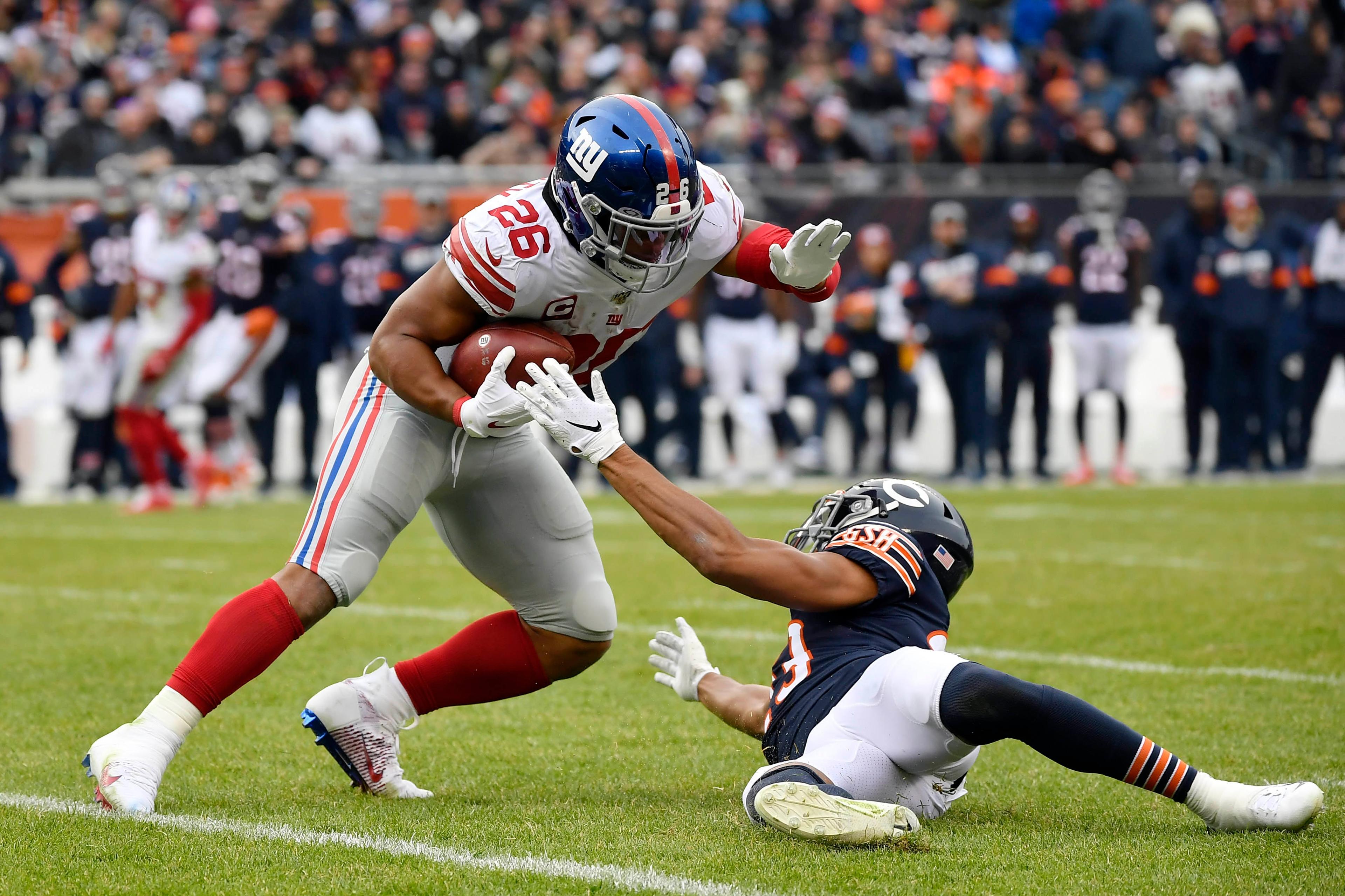 Nov 24, 2019; Chicago, IL, USA; New York Giants running back Saquon Barkley (26) runs in the second against Chicago Bears cornerback Kyle Fuller (23) at Soldier Field. Mandatory Credit: Quinn Harris-USA TODAY Sports