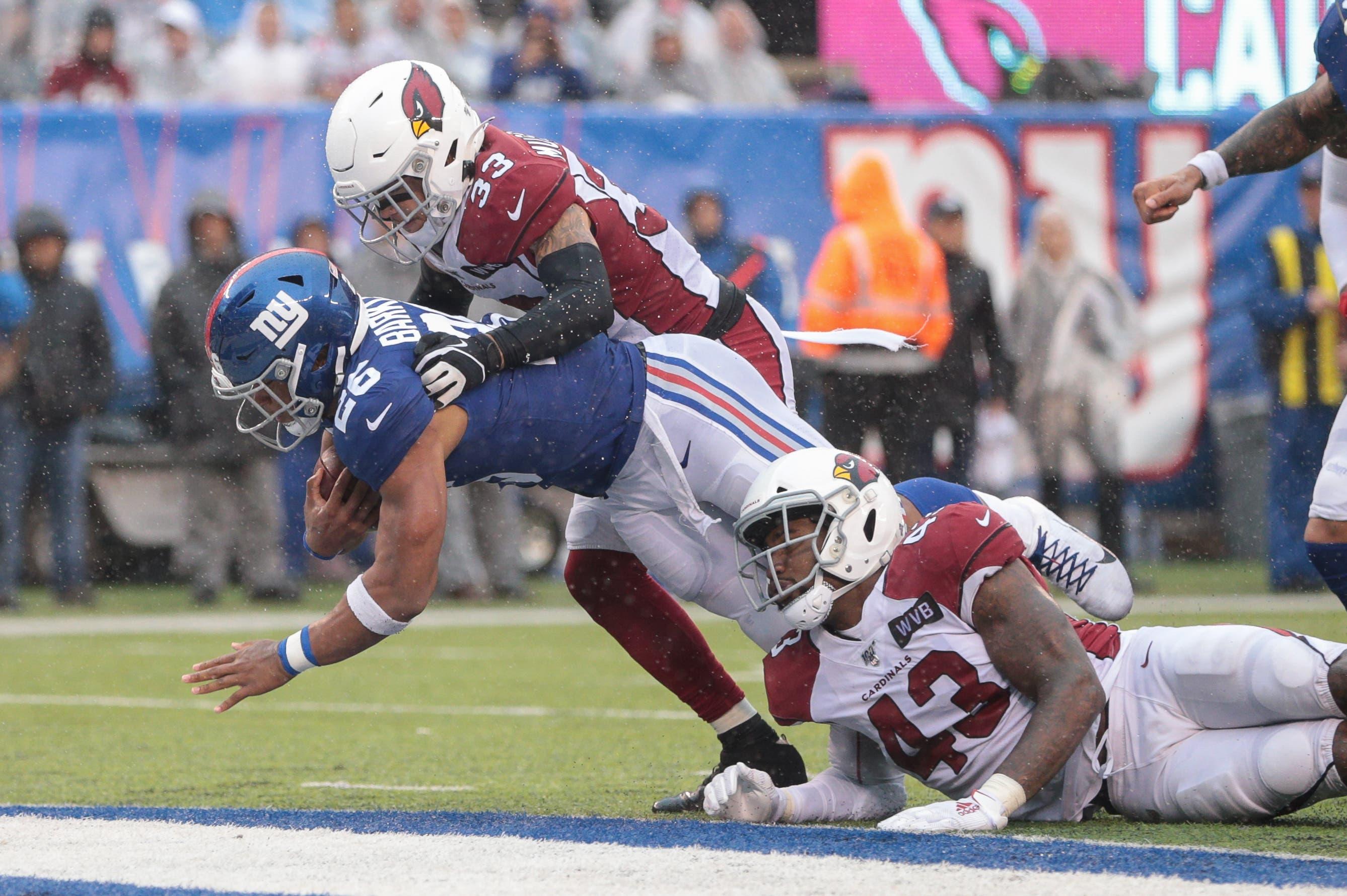 Oct 20, 2019; East Rutherford, NJ, USA; New York Giants running back Saquon Barkley (26) rushes for a touchdown as Arizona Cardinals cornerback Byron Murphy (33) and outside linebacker Haason Reddick (43) tackle during the second half at MetLife Stadium. Mandatory Credit: Vincent Carchietta-USA TODAY Sports / Vincent Carchietta