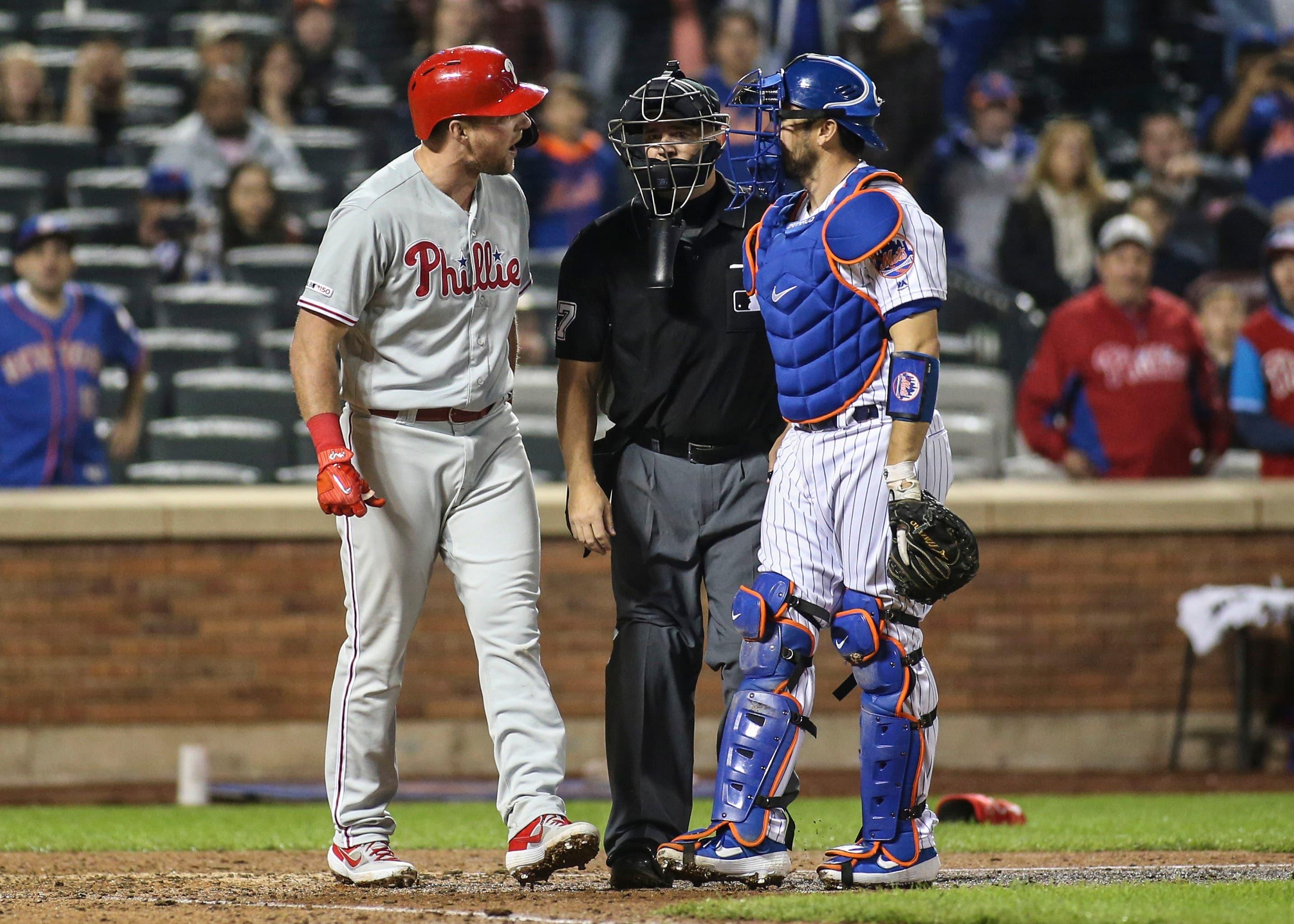 Apr 23, 2019; New York City, NY, USA; Philadelphia Phillies first baseman Rhys Hoskins (17) exchanges words with New York Mets catcher Travis d'Arnaud (18) after almost getting hit by a pitch in the ninth inning at Citi Field. Mandatory Credit: Wendell Cruz-USA TODAY Sports / Wendell Cruz