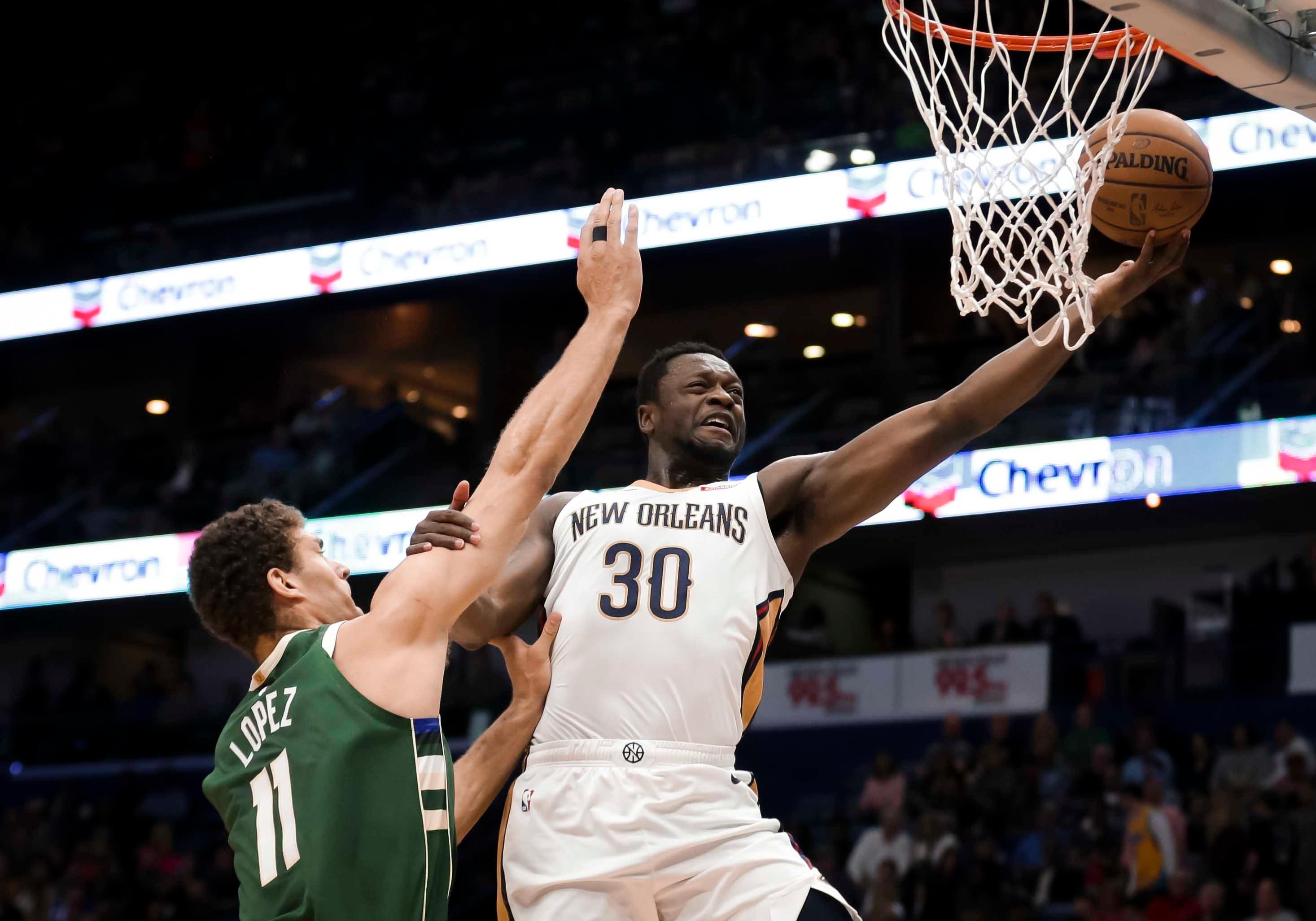 New Orleans Pelicans center Julius Randle shoots over Milwaukee Bucks center Brook Lopez during the first quarter at the Smoothie King Center.