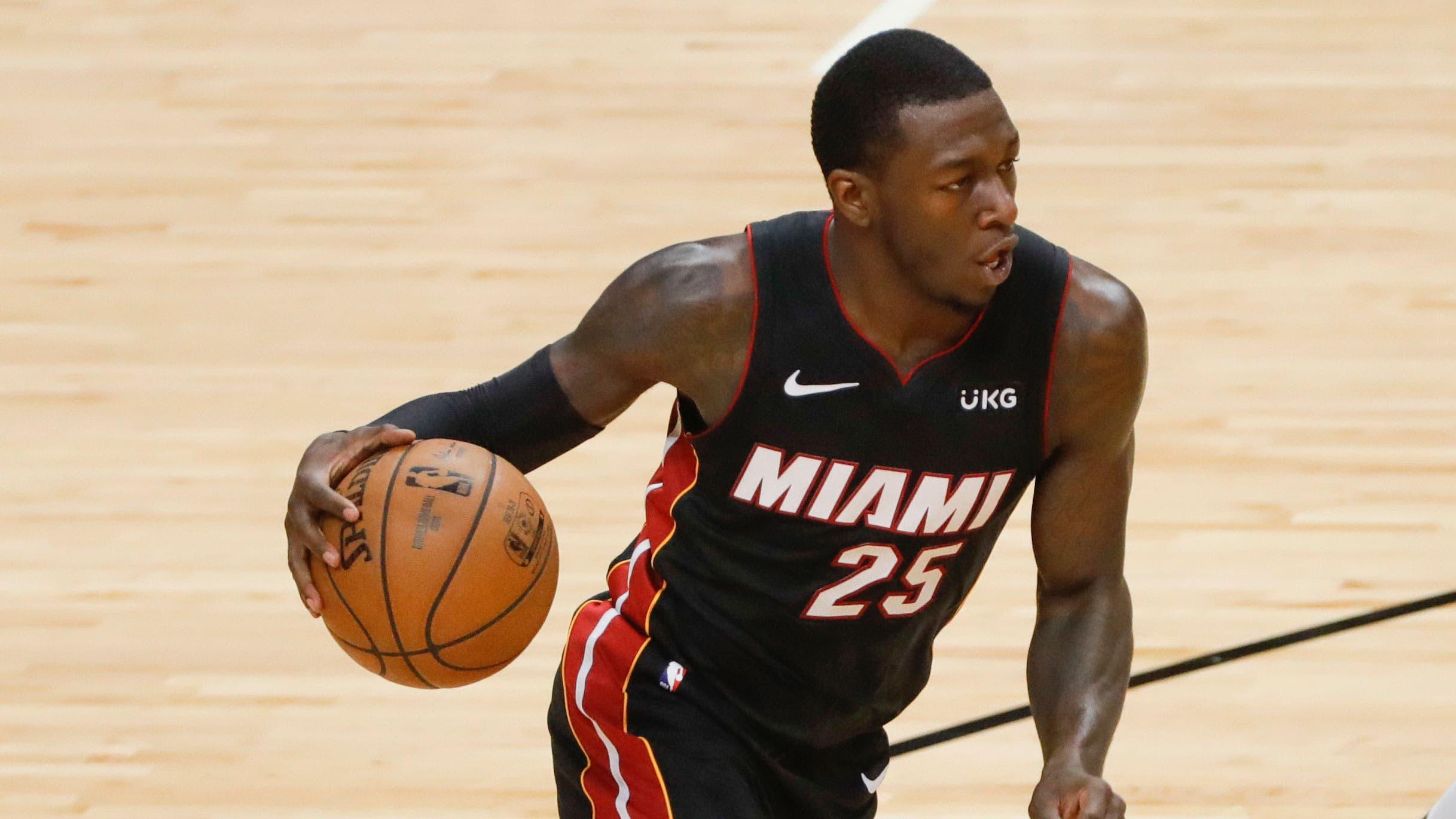 May 29, 2021; Miami, Florida, USA; Miami Heat guard Kendrick Nunn (25) controls the basketball against Milwaukee Bucks forward Khris Middleton (22) during the second quarter of game four in the first round of the 2021 NBA Playoffs at American Airlines Arena. / Sam Navarro-USA TODAY Sports