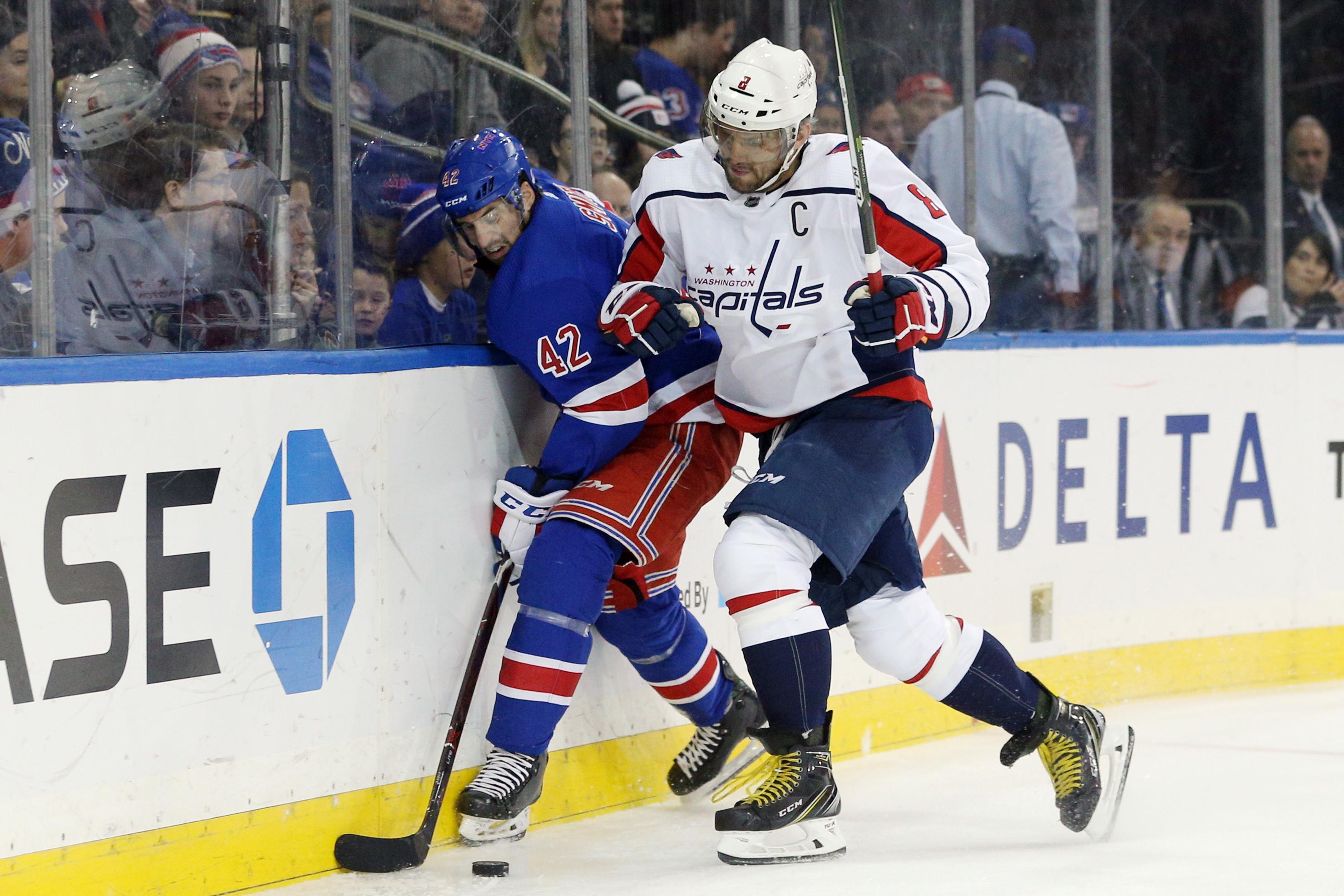 Nov 24, 2018; New York, NY, USA; Washington Capitals left wing Alex Ovechkin (8) hits New York Rangers defenseman Brendan Smith (42) during the first period at Madison Square Garden. Mandatory Credit: Brad Penner-USA TODAY Sports