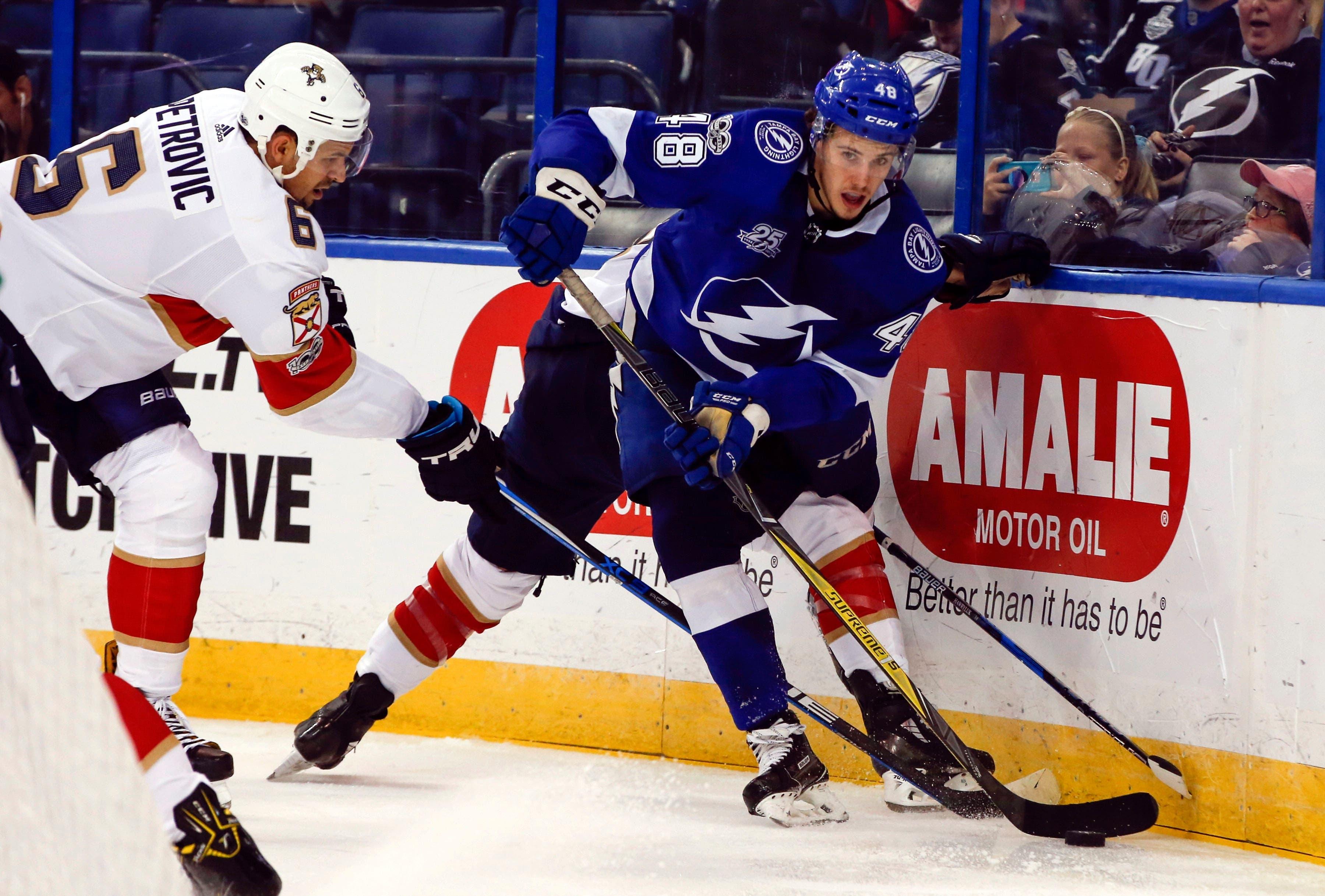 Sep 22, 2017; Tampa, FL, USA; Tampa Bay Lightning center Brett Howden (48) works the puck as Florida Panthers defenseman Alex Petrovic (6) defends during the second period of a hockey game at Amalie Arena. Mandatory Credit: Reinhold Matay-USA TODAY Sports / Reinhold Matay