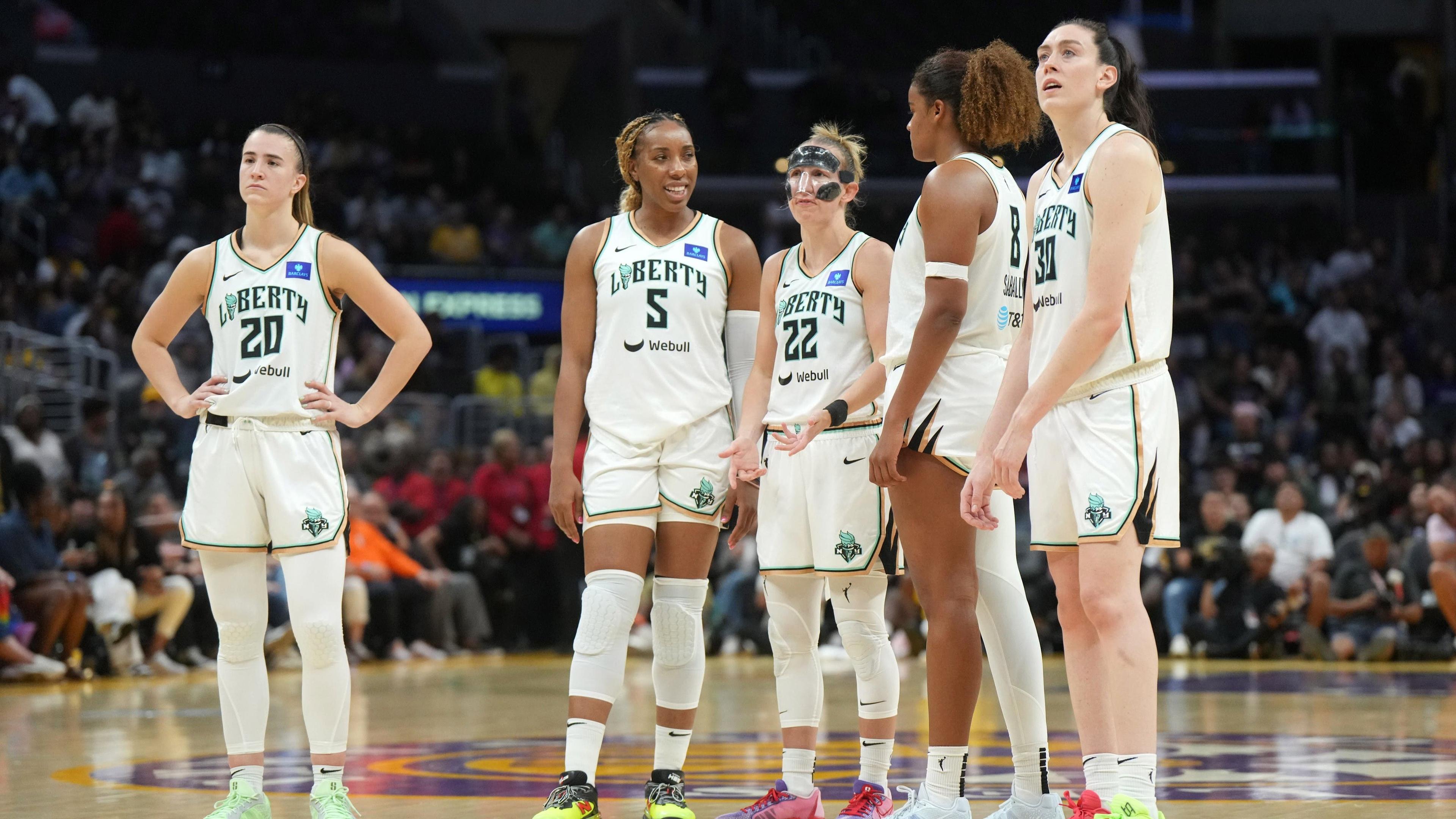 Aug 28, 2024; Los Angeles, California, USA; New York Liberty guard Sabrina Ionescu (20), forward Kayla Thornton (5), guard Courtney Vandersloot (22), forward Nyara Sabally (8) and forward Breanna Stewart (30) react in the second half against the LA Sparks at Crypto.com Arena. / Kirby Lee-Imagn Images