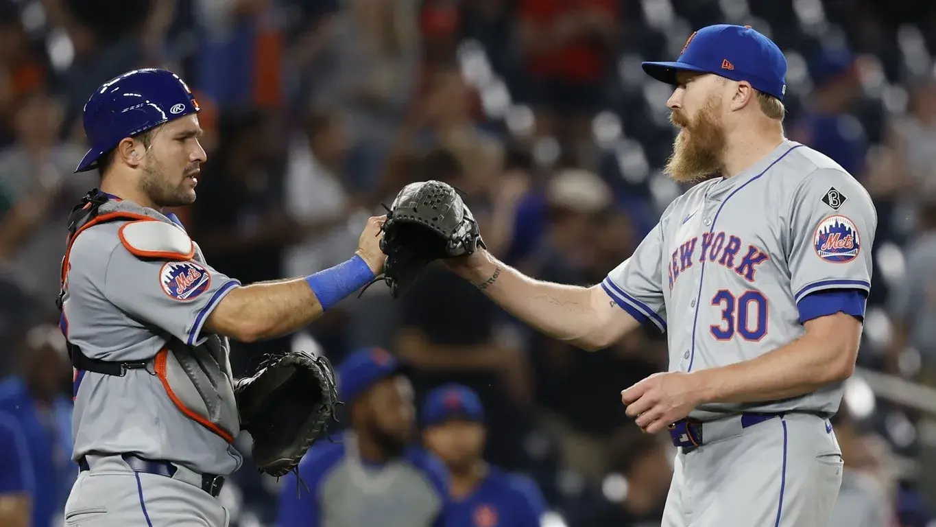 New York Mets catcher Luis Torrens (13) celebrates with Mets pitcher Jake Diekman (30) after the final out against the Washington Nationals at Nationals Park. / Geoff Burke-USA TODAY Sports