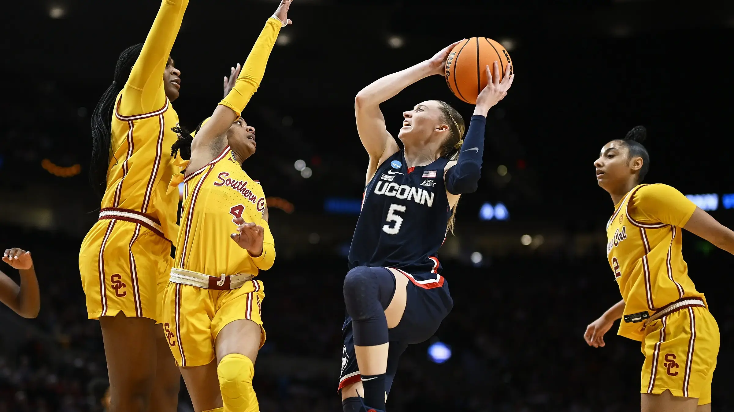 UConn Huskies guard Paige Bueckers (5) drives to the basket during the first half against USC Trojans guard Kayla Williams (4) and center Clarice Akunwafo (34)in the finals of the Portland Regional of the NCAA Tournament at the Moda Center / Troy Wayrynen - USA TODAY Sports