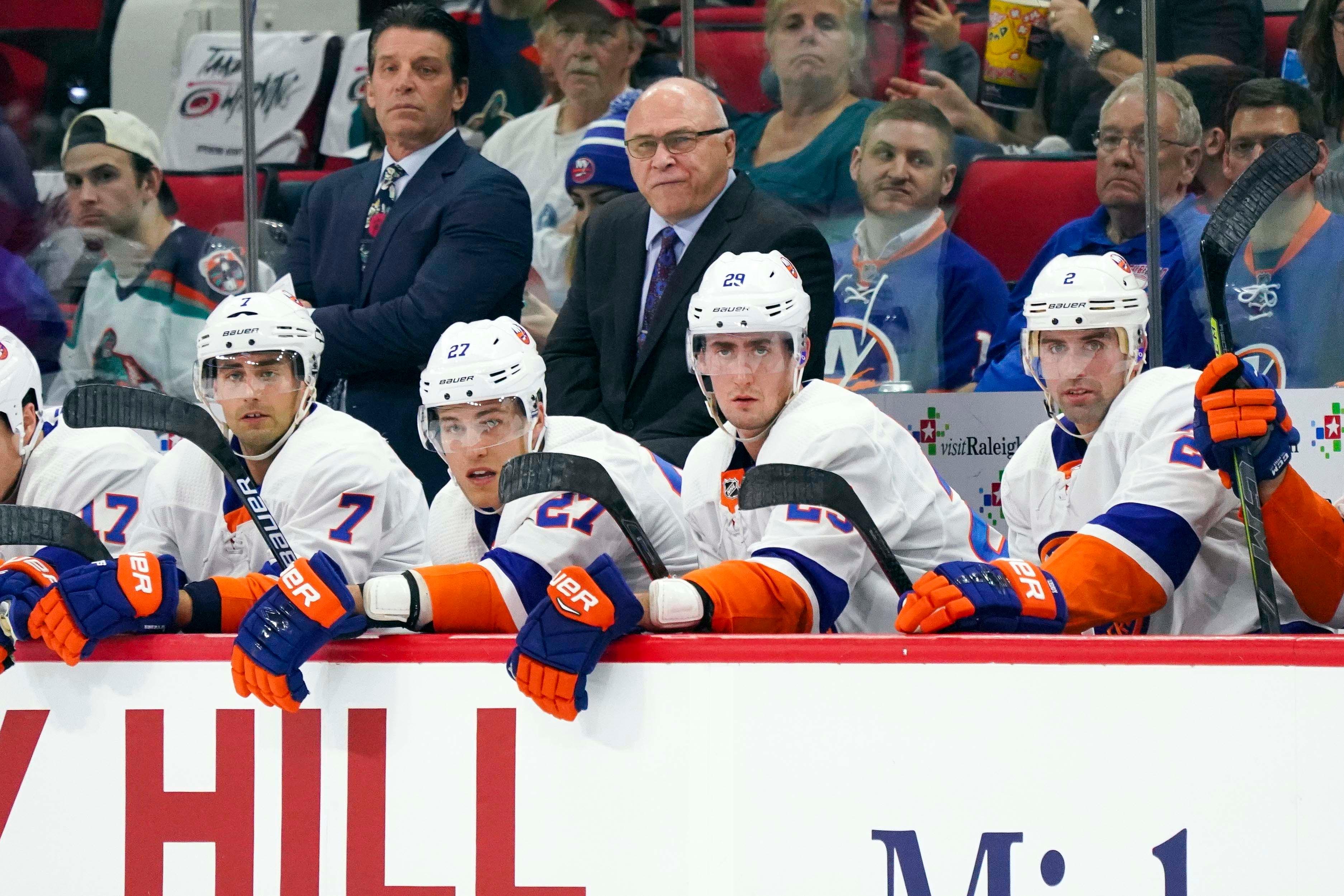 New York Islanders head coach Barry Trotz looks on from behind the players bench against the Carolina Hurricanes at PNC Arena.