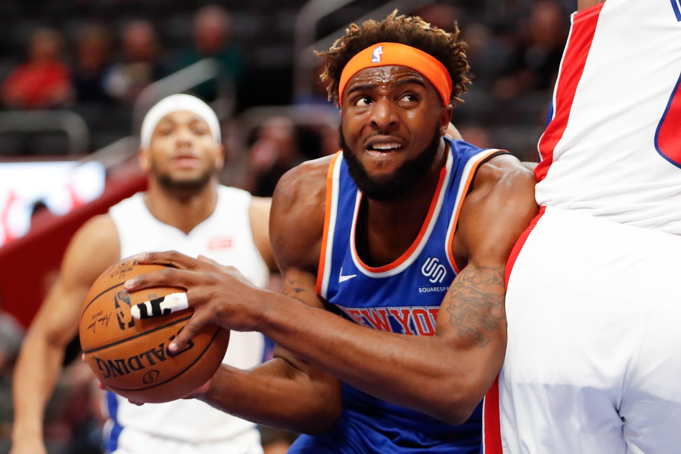 Nov 6, 2019; Detroit, MI, USA; New York Knicks center Mitchell Robinson (23) gets defended by Detroit Pistons center Andre Drummond (0) during the first quarter at Little Caesars Arena. Mandatory Credit: Raj Mehta-USA TODAY Sports / Raj Mehta