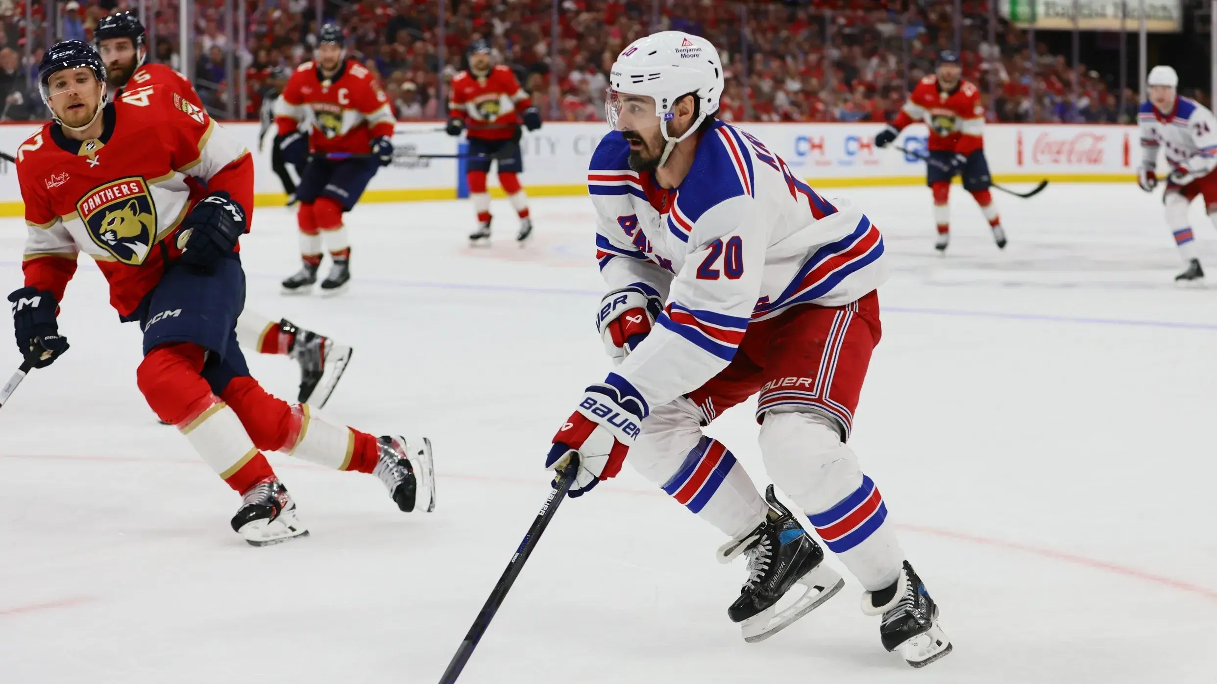 New York Rangers left wing Chris Kreider (20) moves the puck against the Florida Panthers during the third period in game four of the Eastern Conference Final of the 2024 Stanley Cup Playoffs at Amerant Bank Arena. / Sam Navarro-USA TODAY Sports