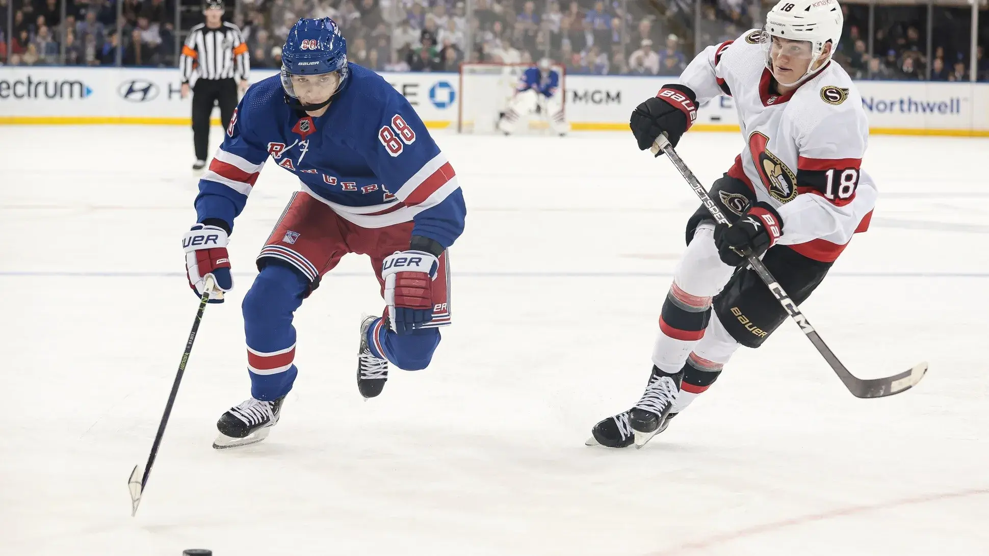 Mar 2, 2023; New York, New York, USA; New York Rangers right wing Patrick Kane (88) skates with the puck against Ottawa Senators left wing Tim Stutzle (18) during the second period at Madison Square Garden. / Vincent Carchietta-USA TODAY Sports