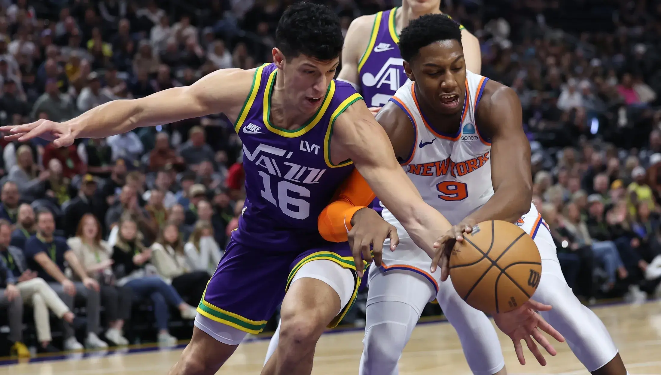 Utah Jazz forward Simone Fontecchio (16) and New York Knicks guard RJ Barrett (9) play for a loose ball during the first quarter at Delta Center. / Rob Gray-USA TODAY Sports