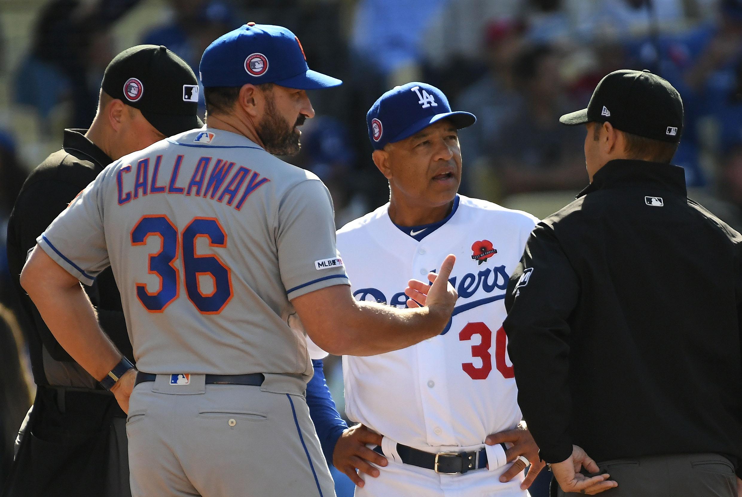 New York Mets manager Mickey Callaway and Los Angeles Dodgers manager Dave Roberts talk before the game at Dodger Stadium.