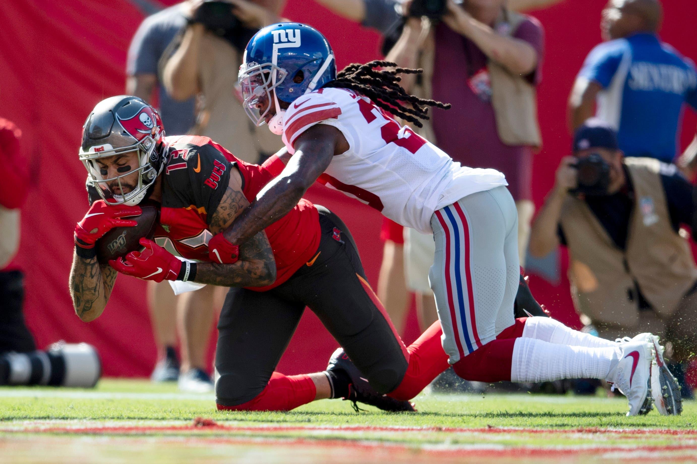 Sep 22, 2019; Tampa, FL, USA; Tampa Bay Buccaneers wide receiver Mike Evans (13) makes a reception for a touchdown against New York Giants cornerback Janoris Jenkins (20) during the first quarter at Raymond James Stadium. Mandatory Credit: Douglas DeFelice-USA TODAY Sports / Douglas DeFelice