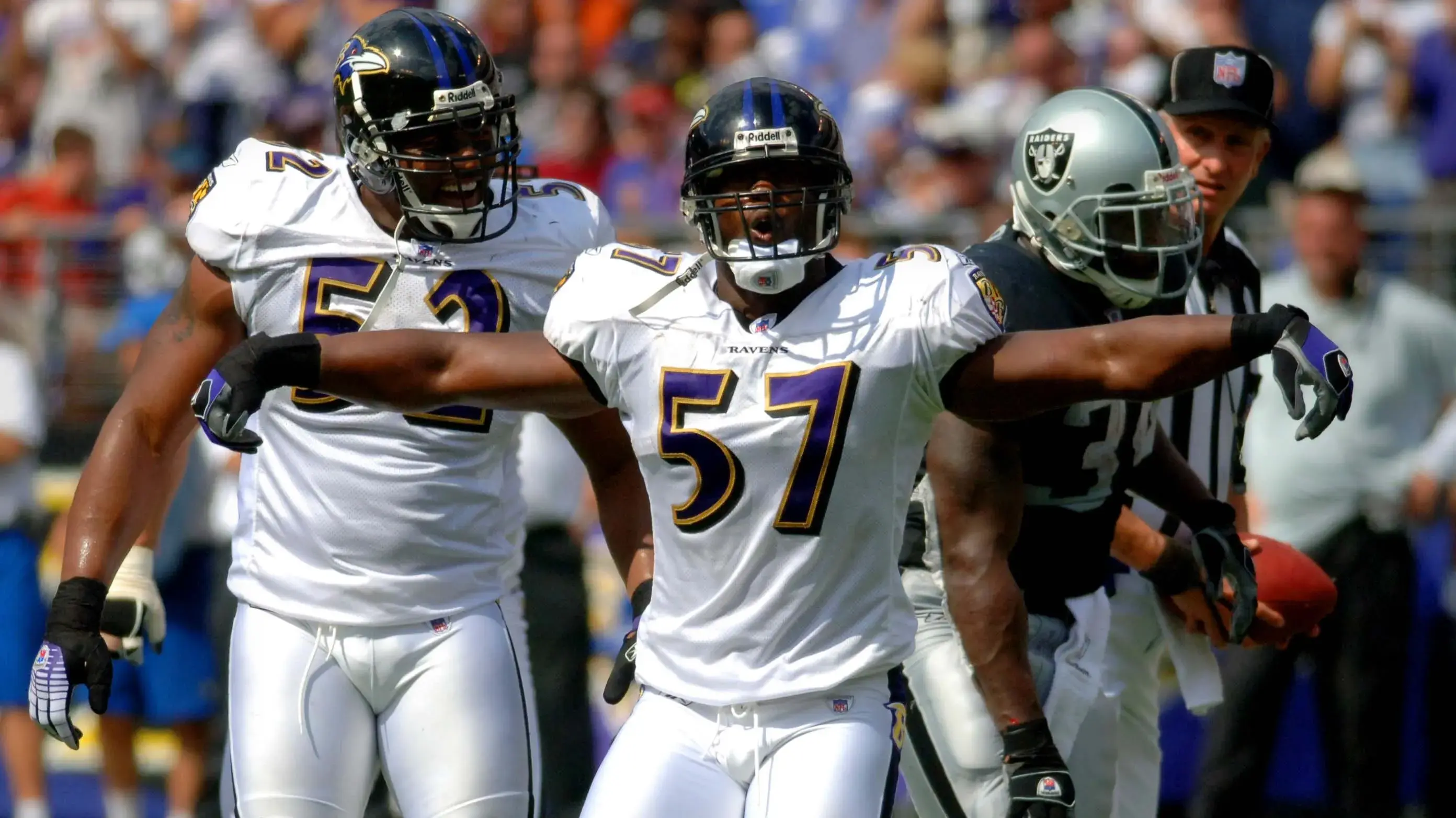 Baltimore Ravens linebackers Bart Scott, center, and Ray Lewis, left, celebrate a tackle on Oakland Raiders running back LaMont Jordan (right) during the Ravens' 28-6 victory over the Oakland Raiders / Kirby Lee-USA TODAY Sports